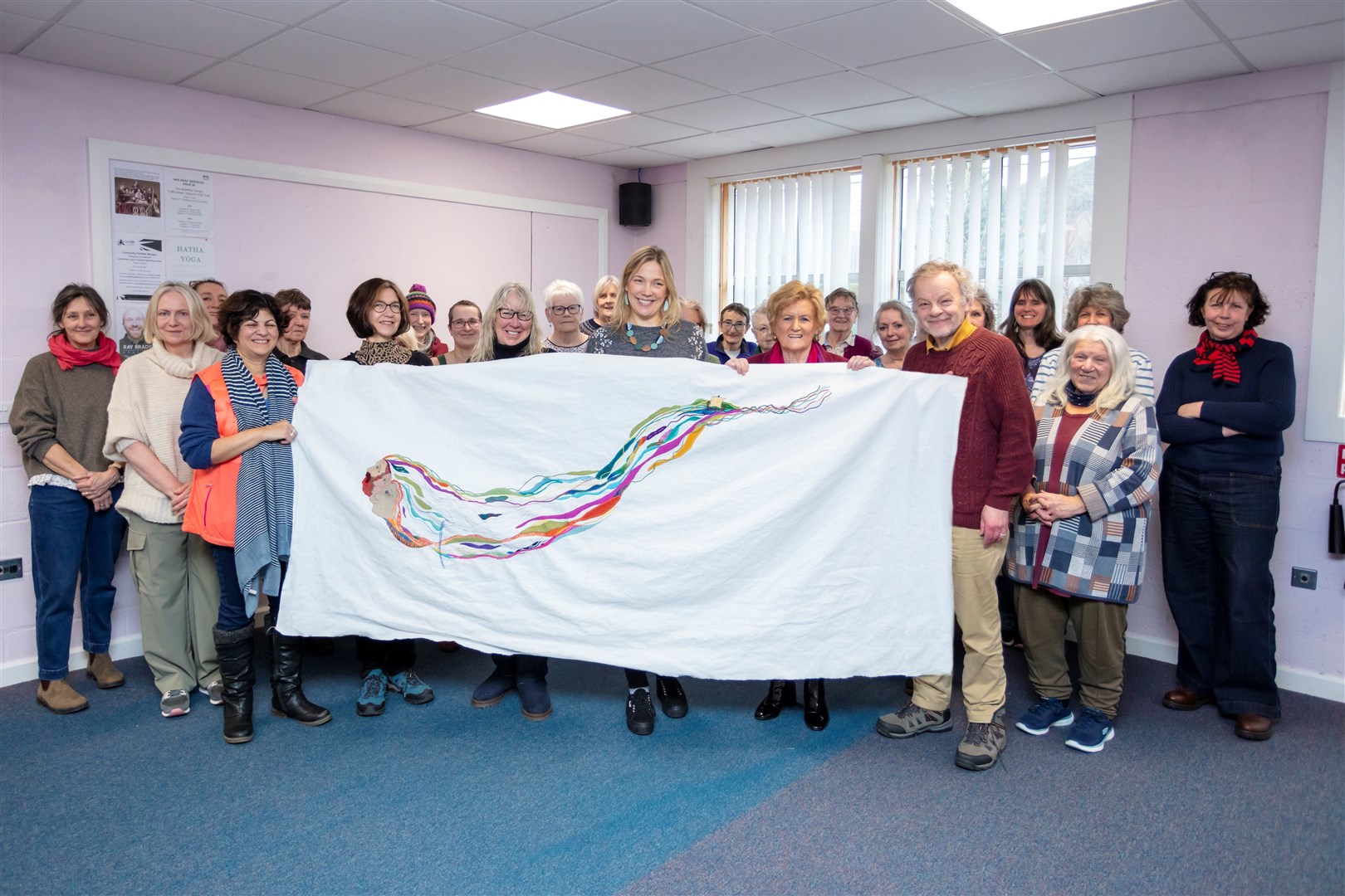 Cllr Biz Campbell, Andrew Crummy MBE, designer, and Kirstie Campbell, stitch coordinator, with Ullapool area community stitchers. Picture: SOTHI/Steven Gourlay.