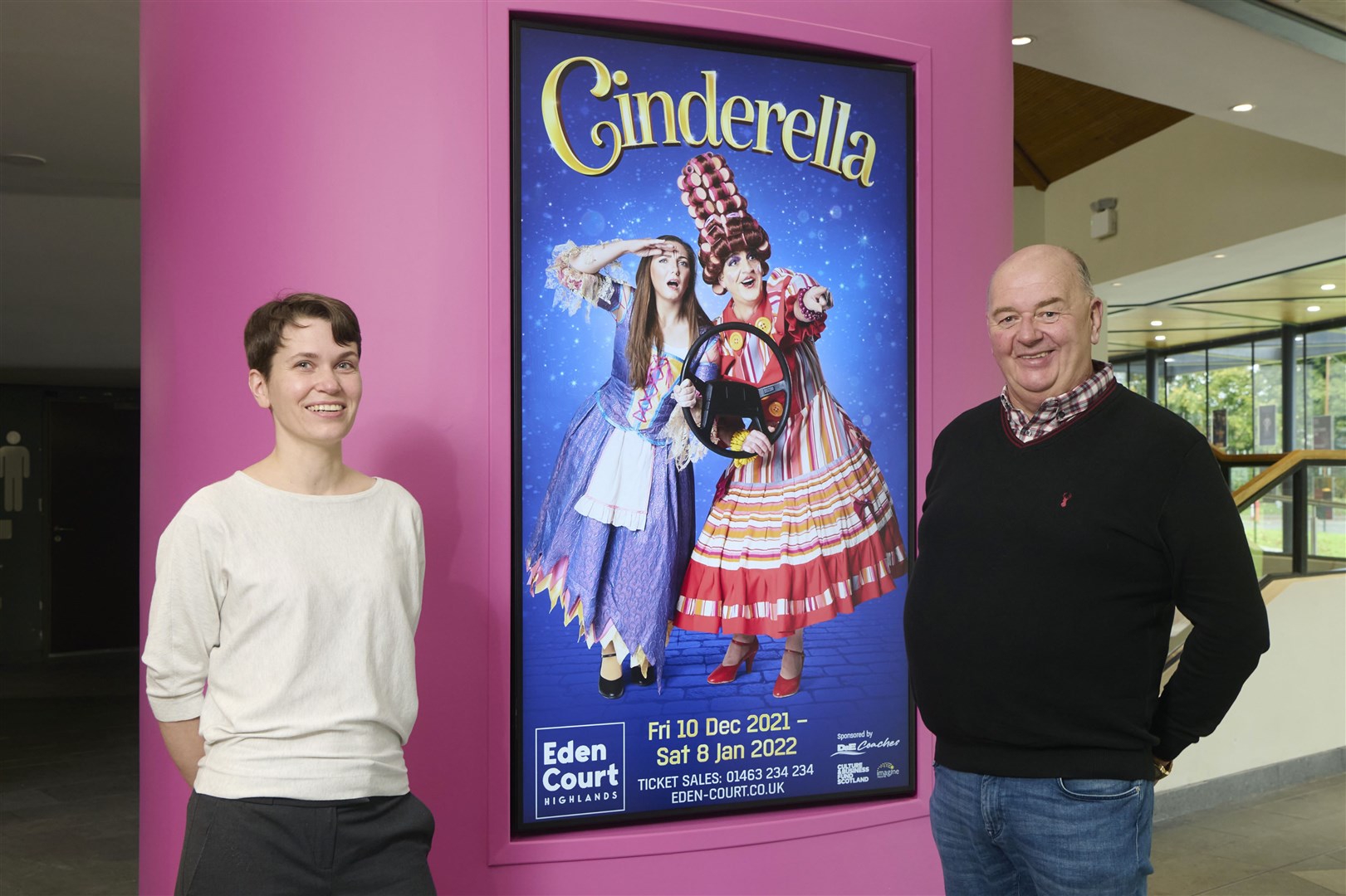 Eden Court fundraising manager Aelish O'Rourke and D&E managing director Donald Mathieson inspect a new plasma screen advert for the pantomime.