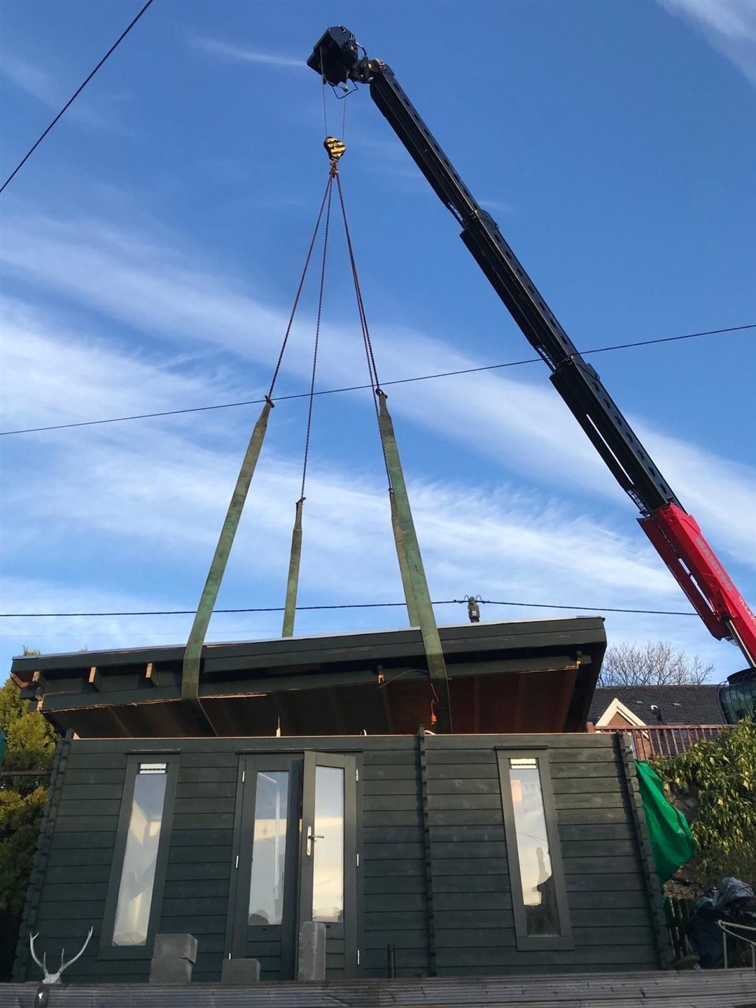 The roof being replaced back on to Mairearad Green's studio. Picture: Charlotte Watters.