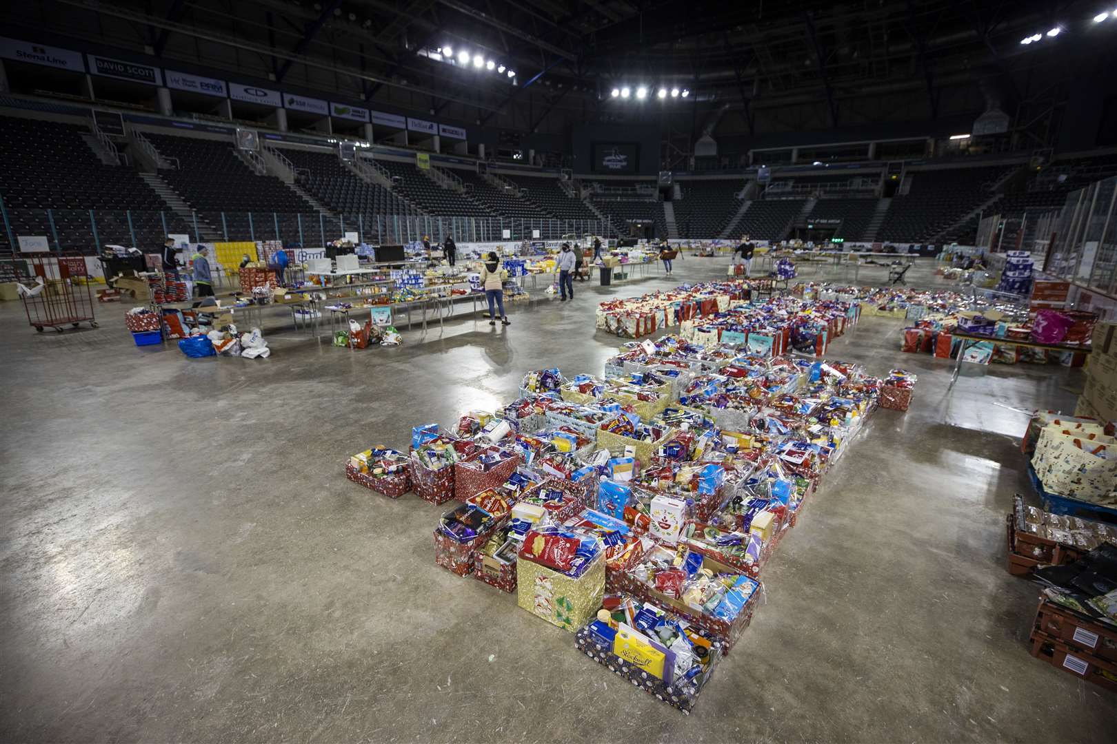 Volunteers sorting Christmas food parcels and hampers on behalf of the North Belfast Advice Partnership last December at the SSE Arena Belfast (Liam McBurney/PA)