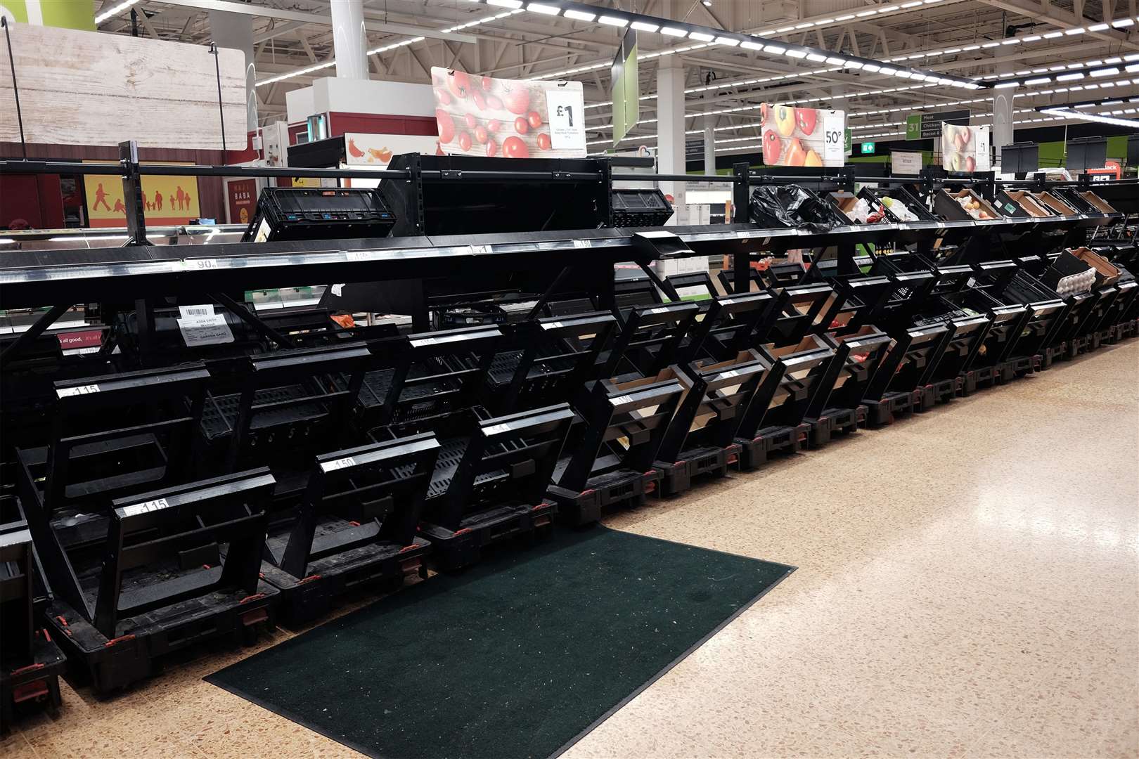 Empty shelves in the fruit and vegetable section of an Asda store in London (Yui Mok/PA)