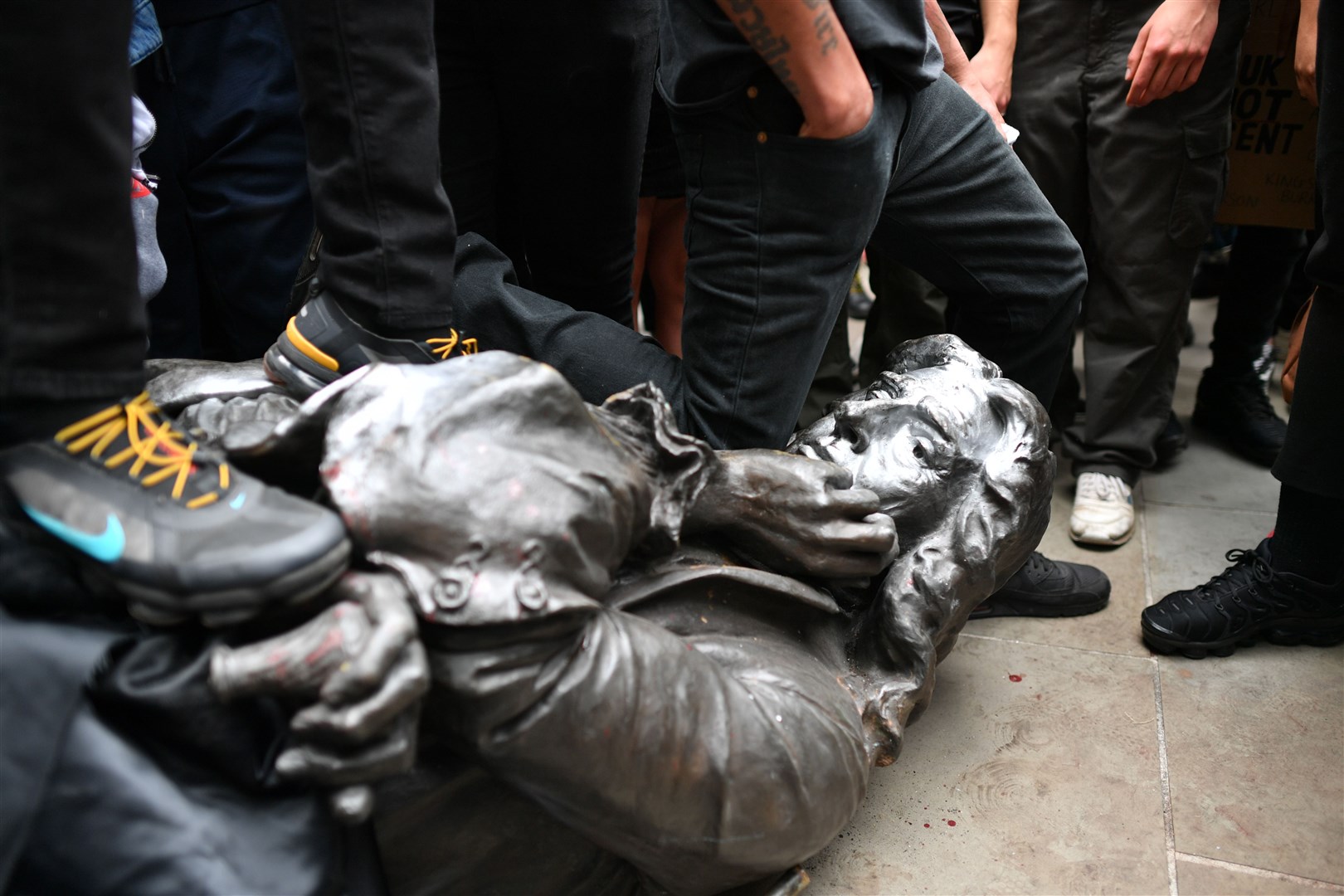 The Edward Colston statue at the feet of protesters (Ben Birchall/PA)