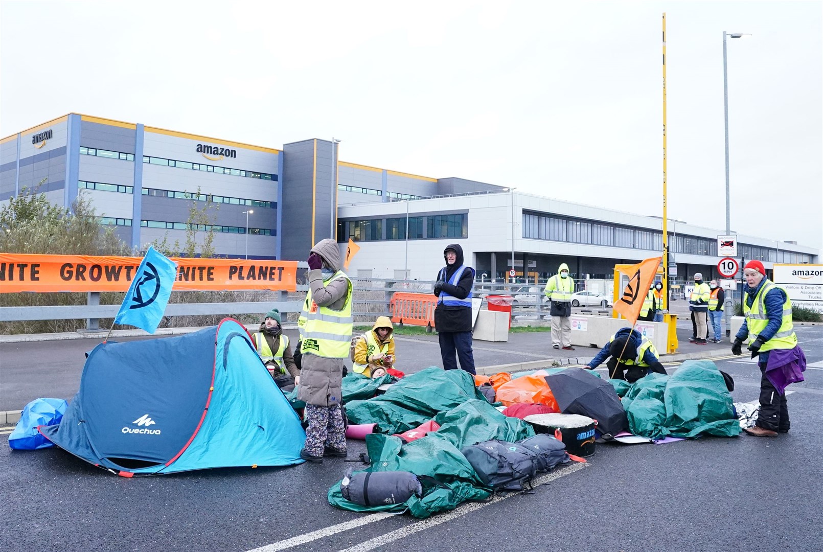 Activists block the entrance to the Amazon centre in Tilbury, Essex (Ian West/PA)