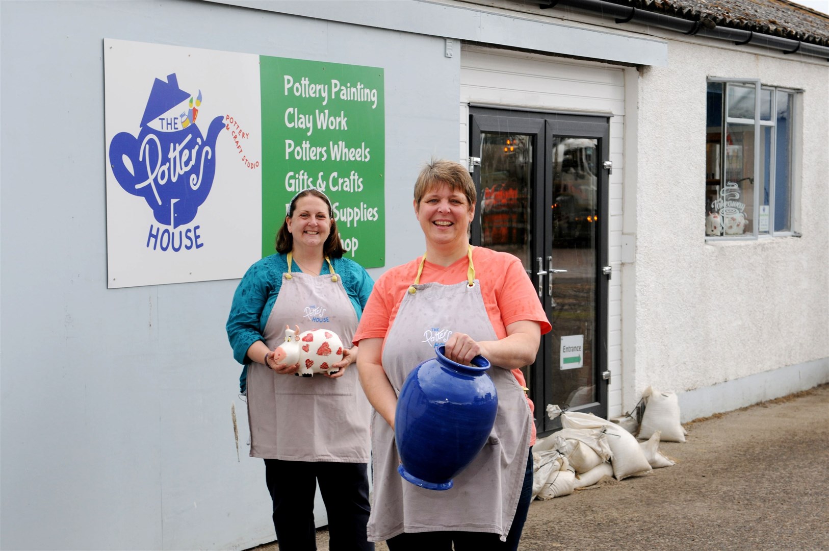 The Potter's House owner Fiona Warren (right) with staff member Lexi Evans were putting a brave face on it as they hoped to avoid another flooding disaster. Picture: James Mackenzie