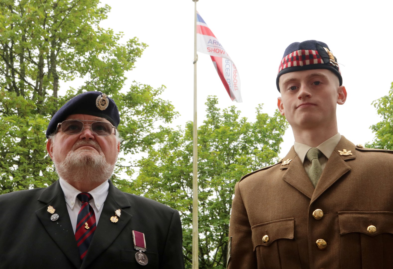 Fraser Campbell, RBLS and Lord-Lieutenant's Cadet, Corporal Calum Sutherland in front of the raised flag. Picture: James Mackenzie.