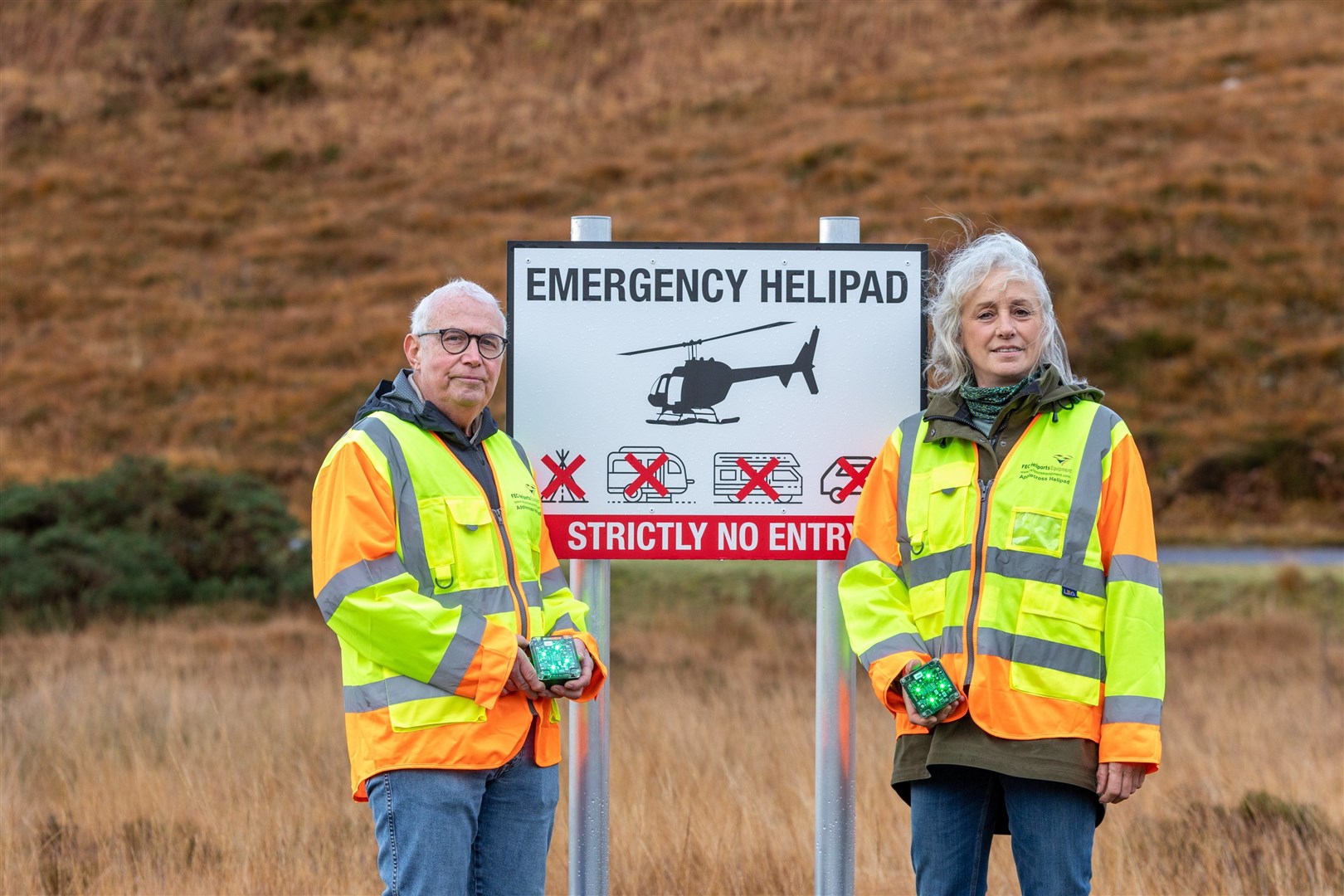 Dr Chris Ward, who helped to build the helipad in Applecross in 2021 and Heather Teale revealing the new lighting. Picture: Annie MacDonald