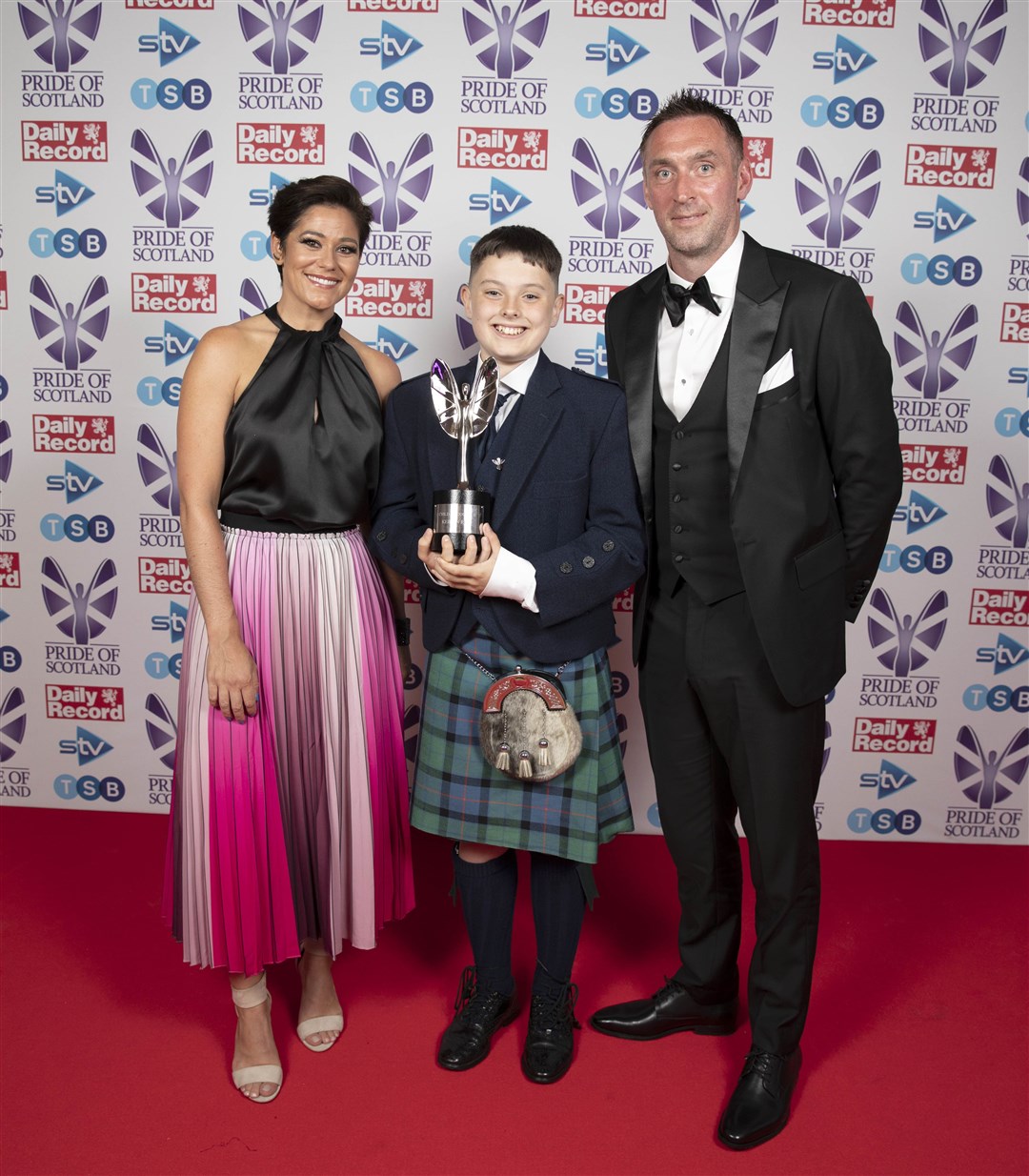 Kieran Reid, winner of the Child of Courage award, with presenters Allan McGregor and Eilidh Barbour at the Pride of Scotland awards ceremony.
