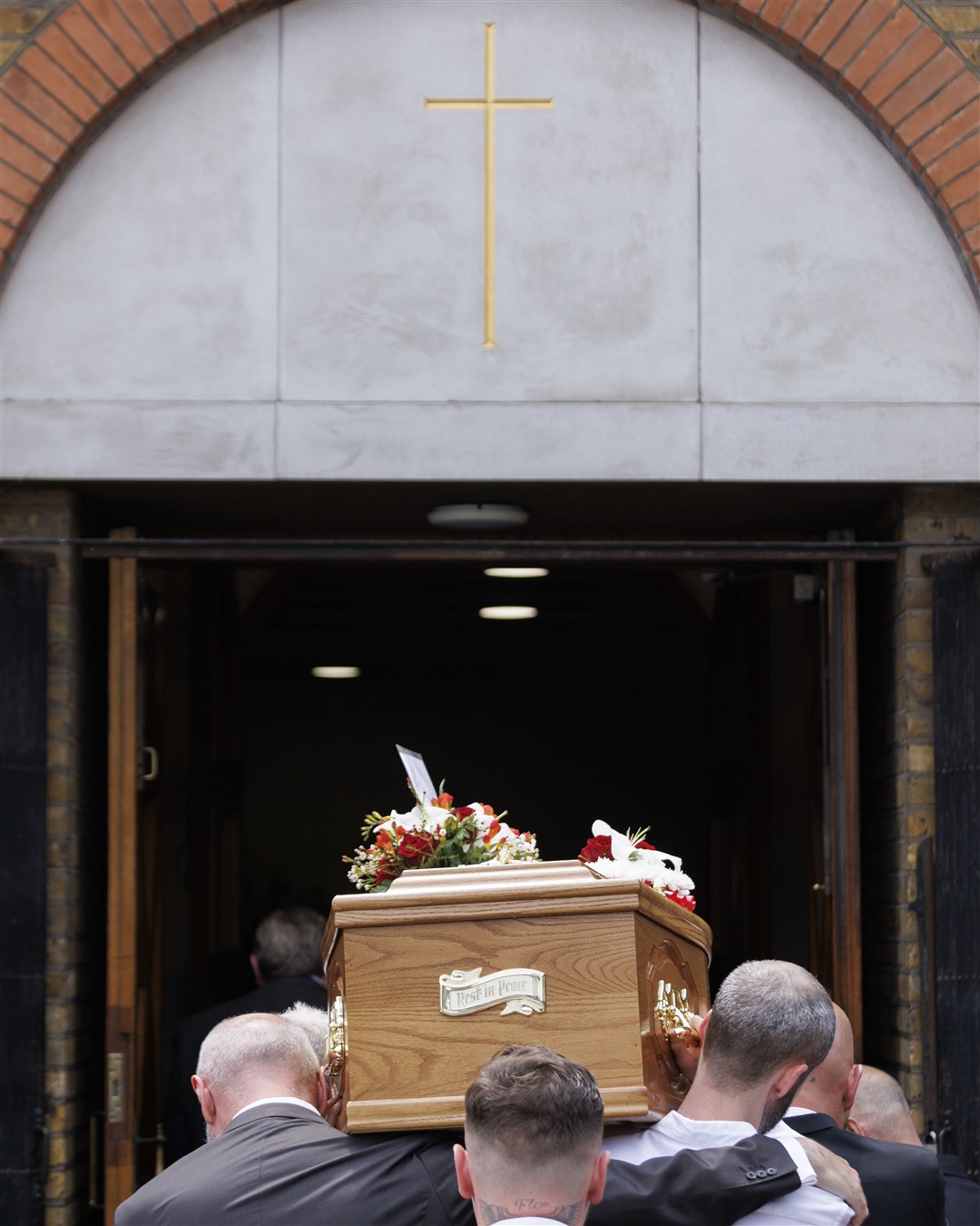 The coffin of Hugh Callaghan is carried into the Immaculate Heart of Mary and St Dominic church (Belinda Jiao/PA)