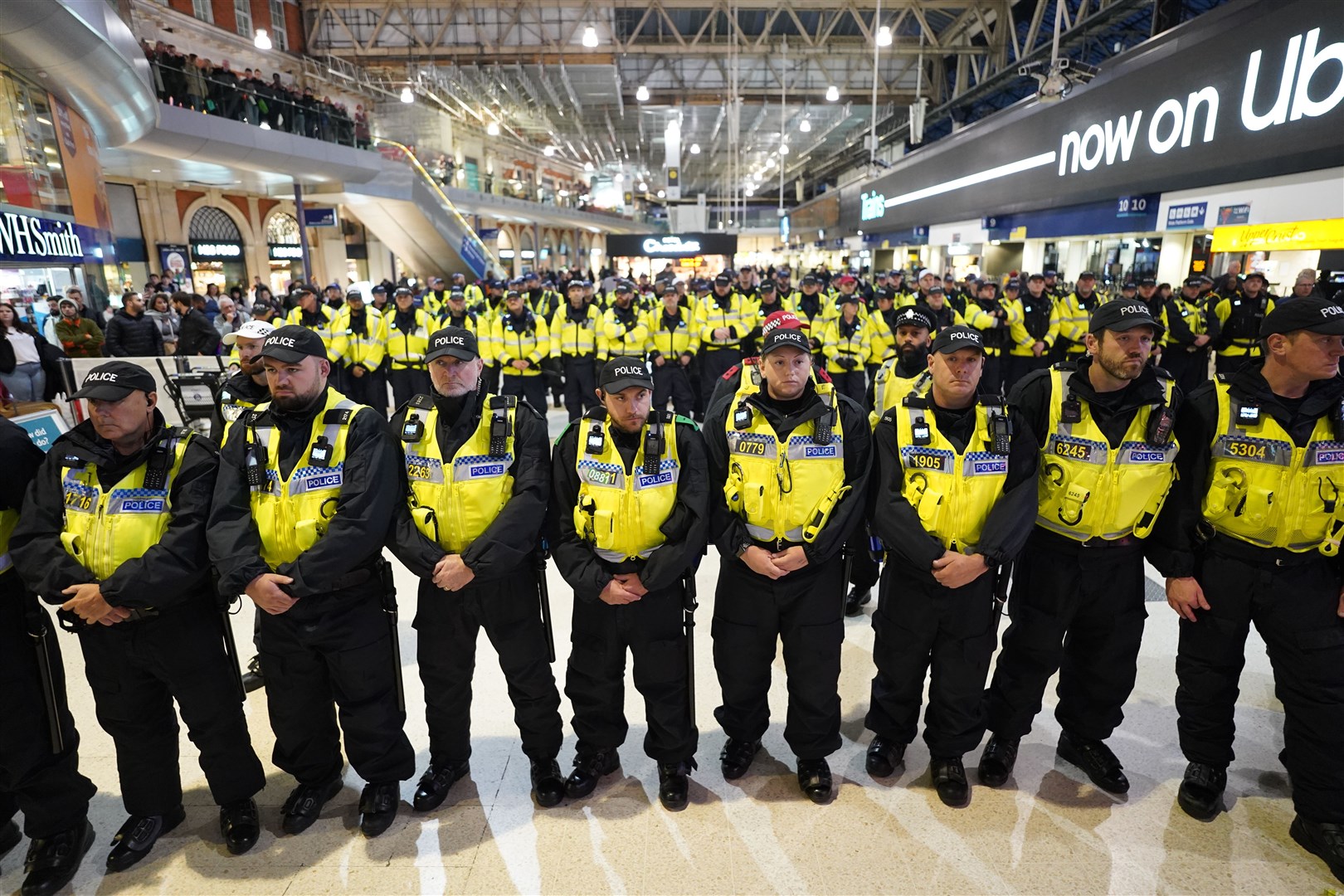 Police officers line up on the concourse after pro-Palestinian protesters took part in a sit-in demonstration at London’s Waterloo Station calling for a ceasefire in Gaza (Stefan Rousseau/PA)