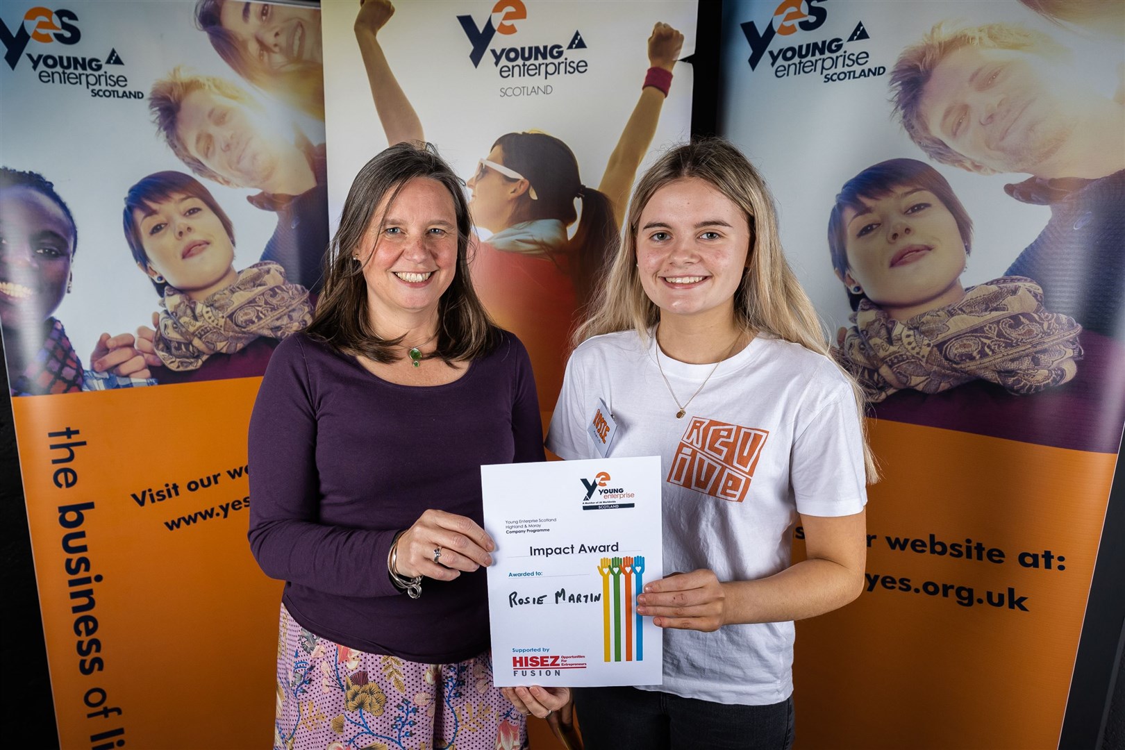 Polly Chapman of HISEZ with Impact Award winner Rosie Martin of Fortrose Academy's Revive team.