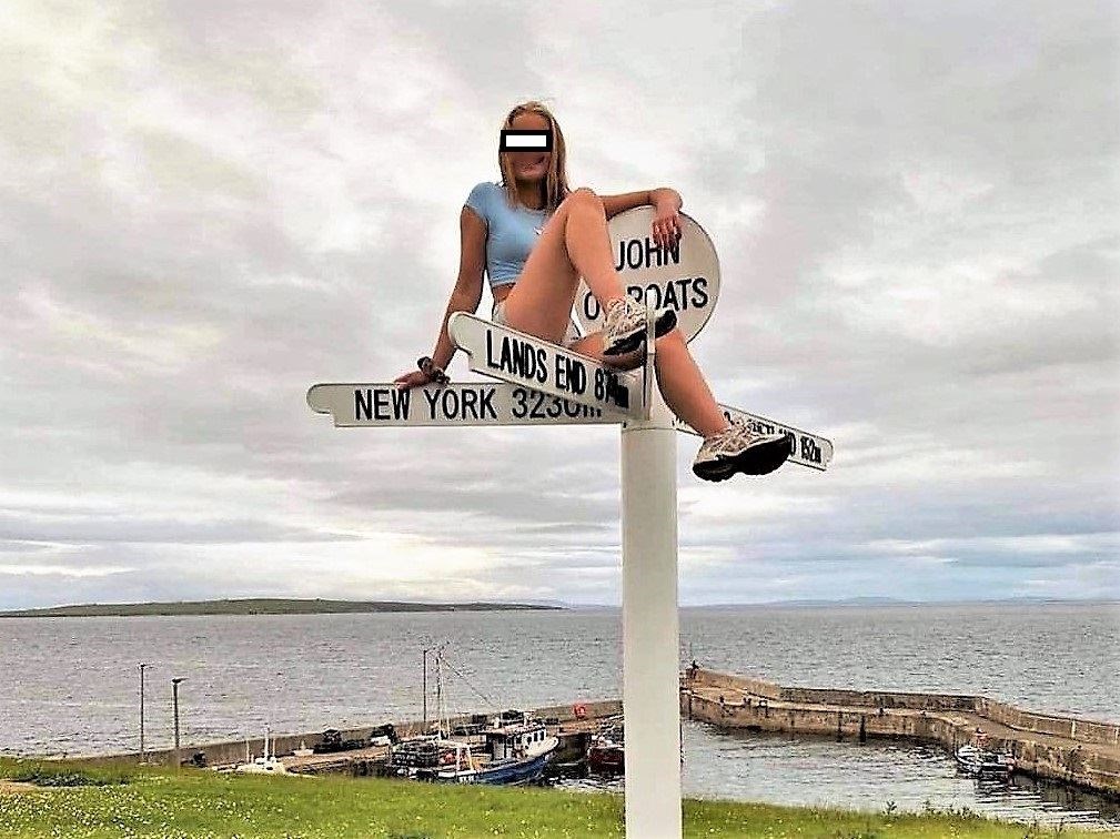 A young woman, said to be a law student, was lambasted on social media for sitting on top of the sign.