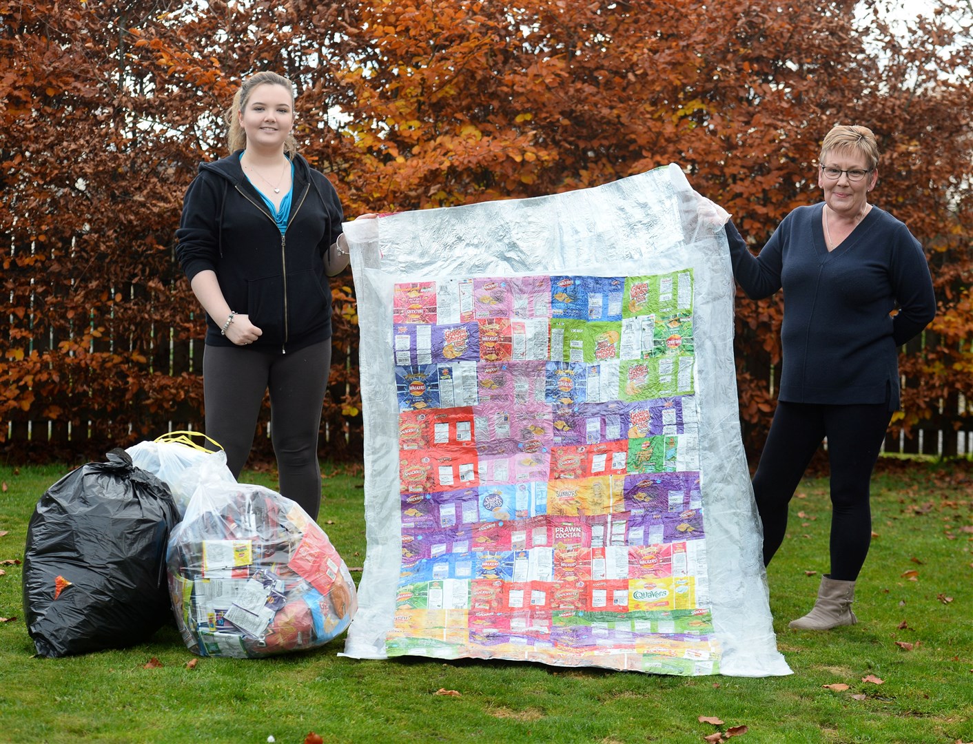 Aine-Mhairi Nolan is creating sleeping bag protectors and blankets out of recycled crisps packets and plastic for the homeless. She's pictured with mum Pamela who is helping her out Picture: Gary Anthony