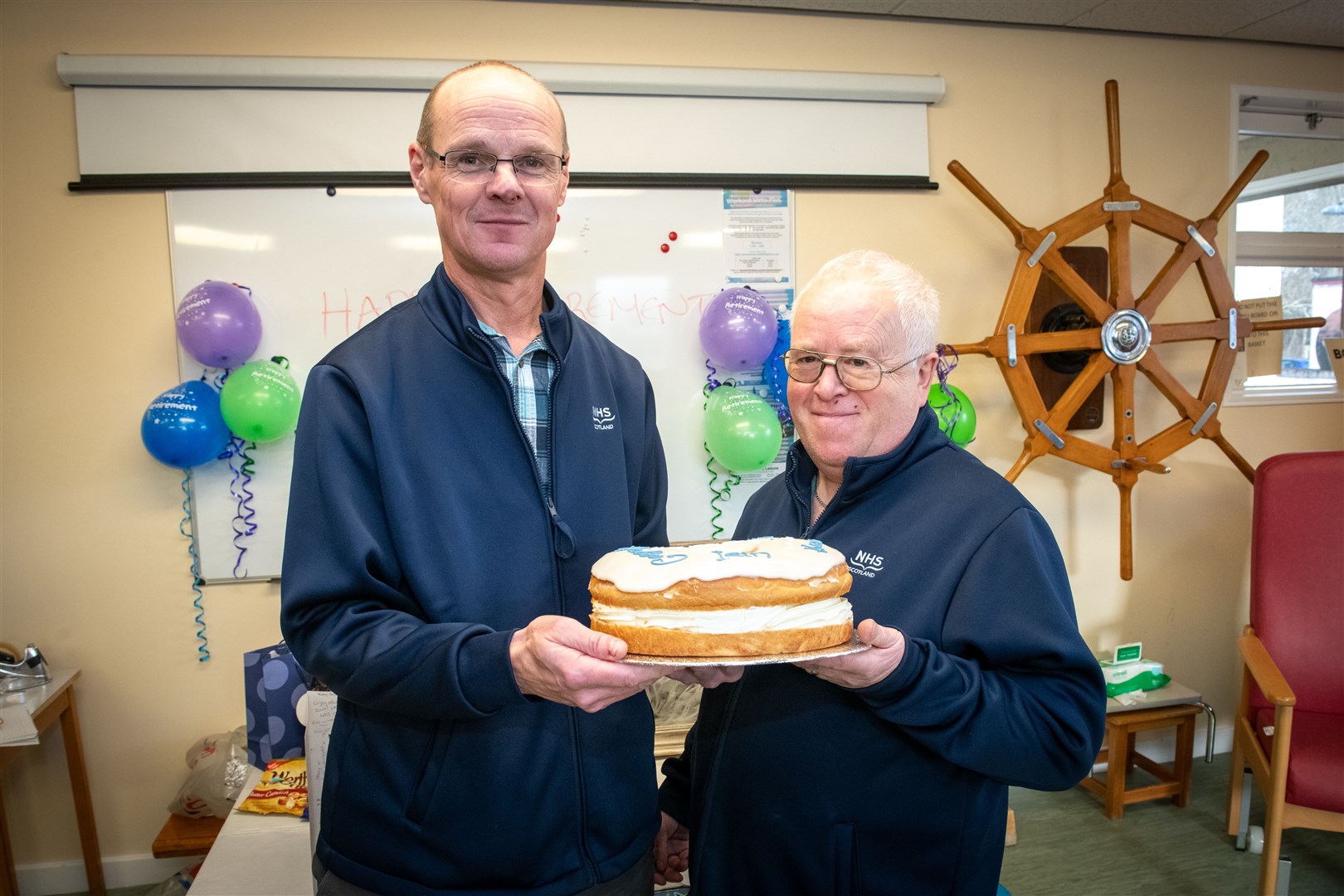 Iain Matheson is greeted with a cake by Kenny Rodgers, Mid Ross District manager, on his retiral. Picture: Callum Mackay