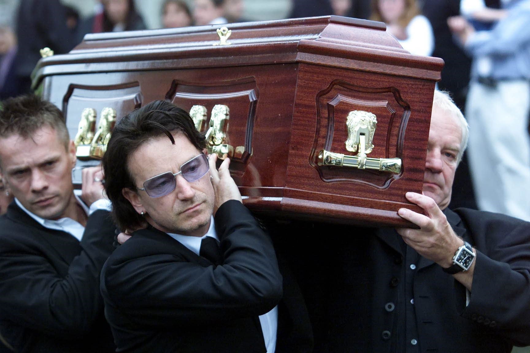 Bono helps carry his father Bob Hewson’s coffin, at his funeral at the Church of Assumption, Howth, Co Dublin (PA)