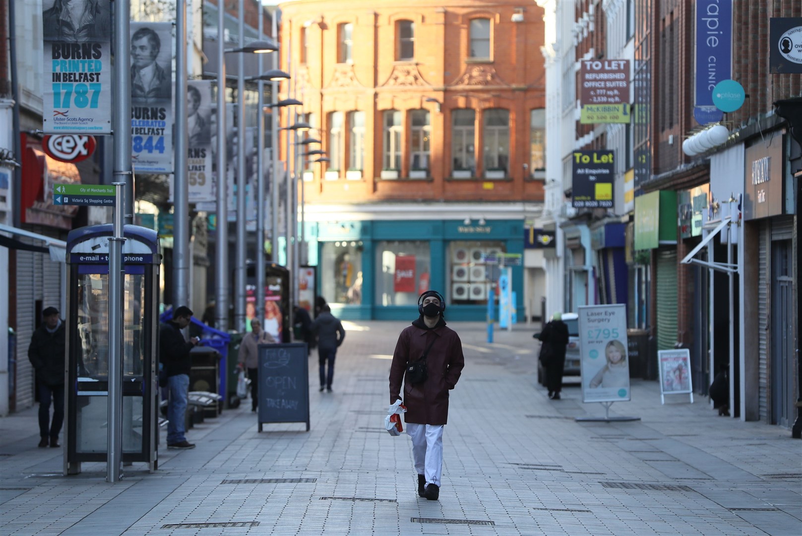 A man walks down a quiet street in Belfast city centre as the six week lockdown in Northern Ireland continues (Brian Lawless/PA)