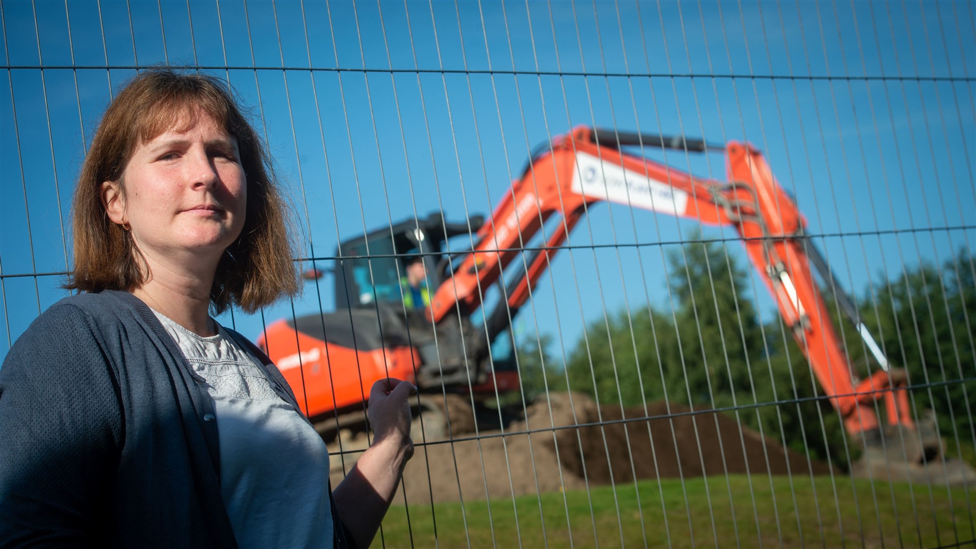 Diggers prepare the ground at Invergordon Academy as Elizabeth McPhail looks on. Picture: Callum Mackay