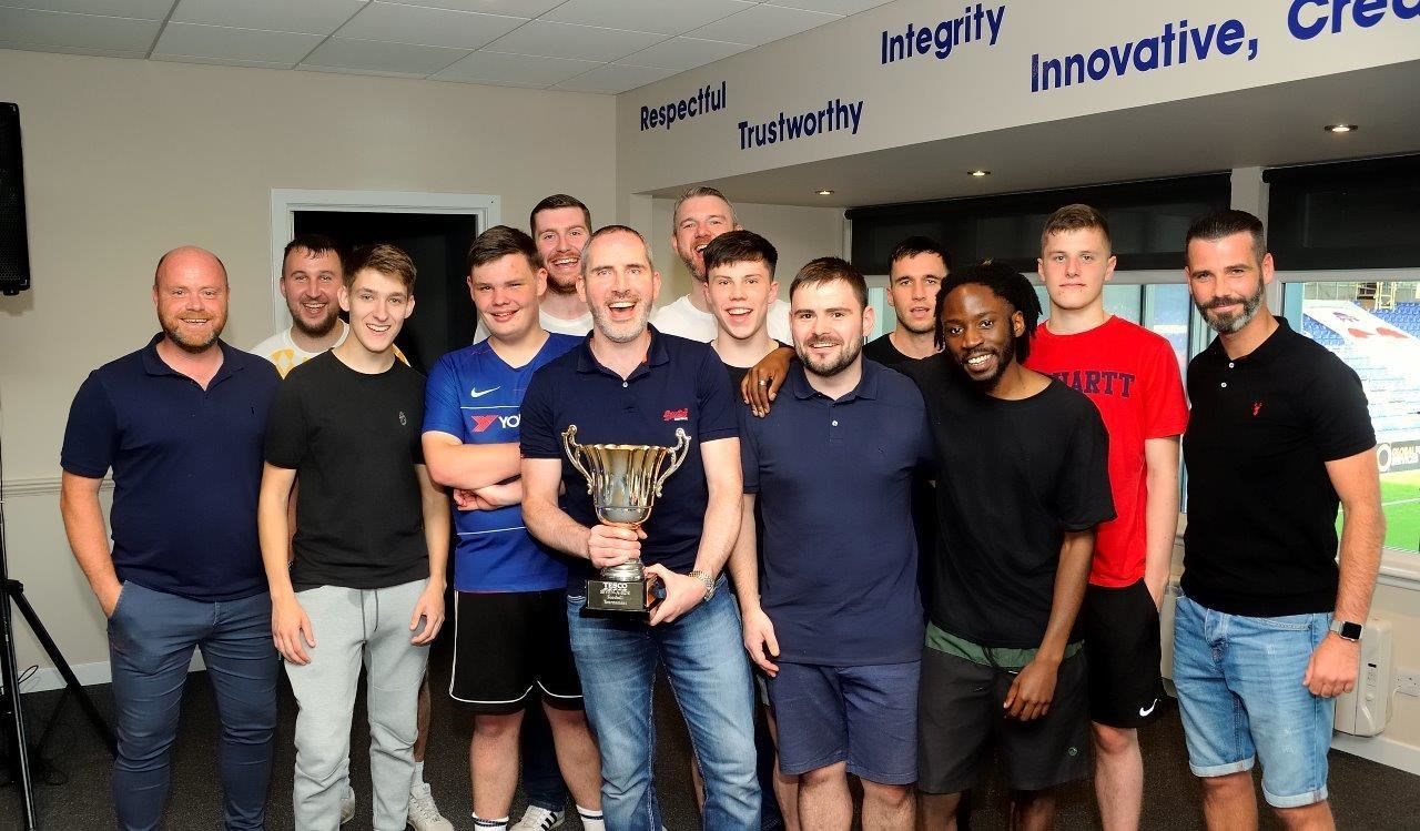 Ross County co-managers Steven Fergus (left) and Stuart Kettlewell flank the winning team from Inverness Tesco Extra. Picture: Brian Alexander.