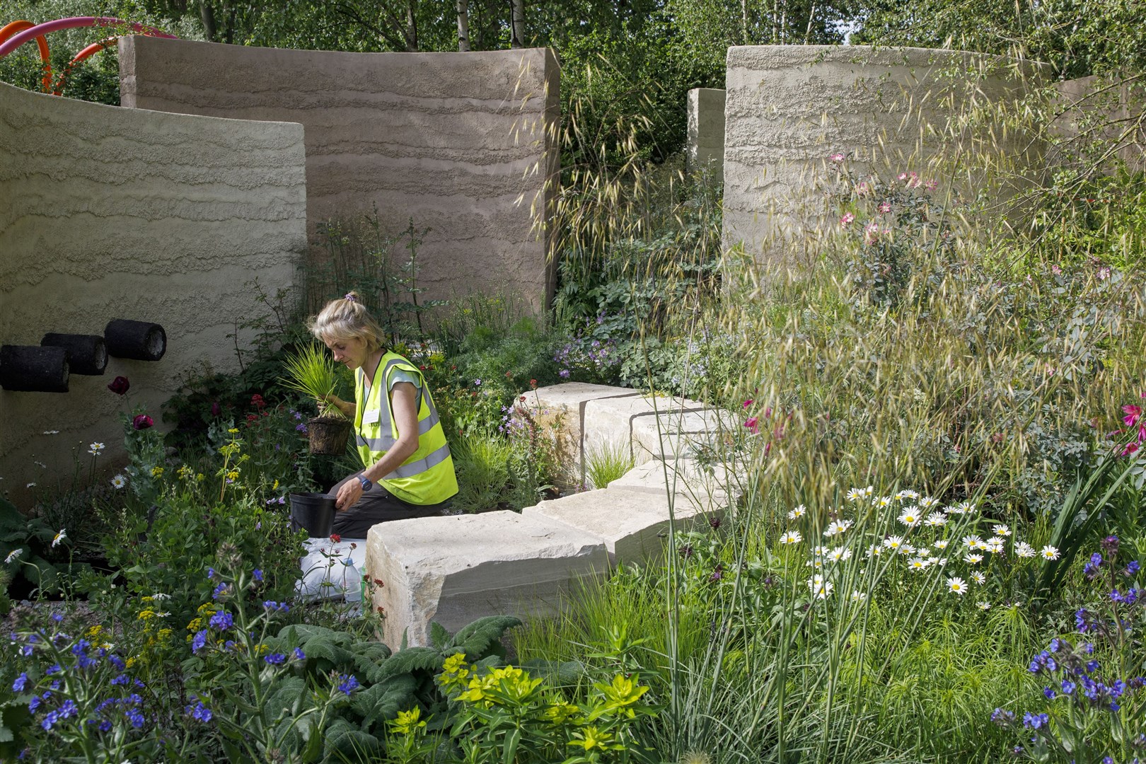 A member of the team works at The Mind Garden designed by Andy Sturgeon during the build-up to the show (Luke MacGregor/RHS/PA)