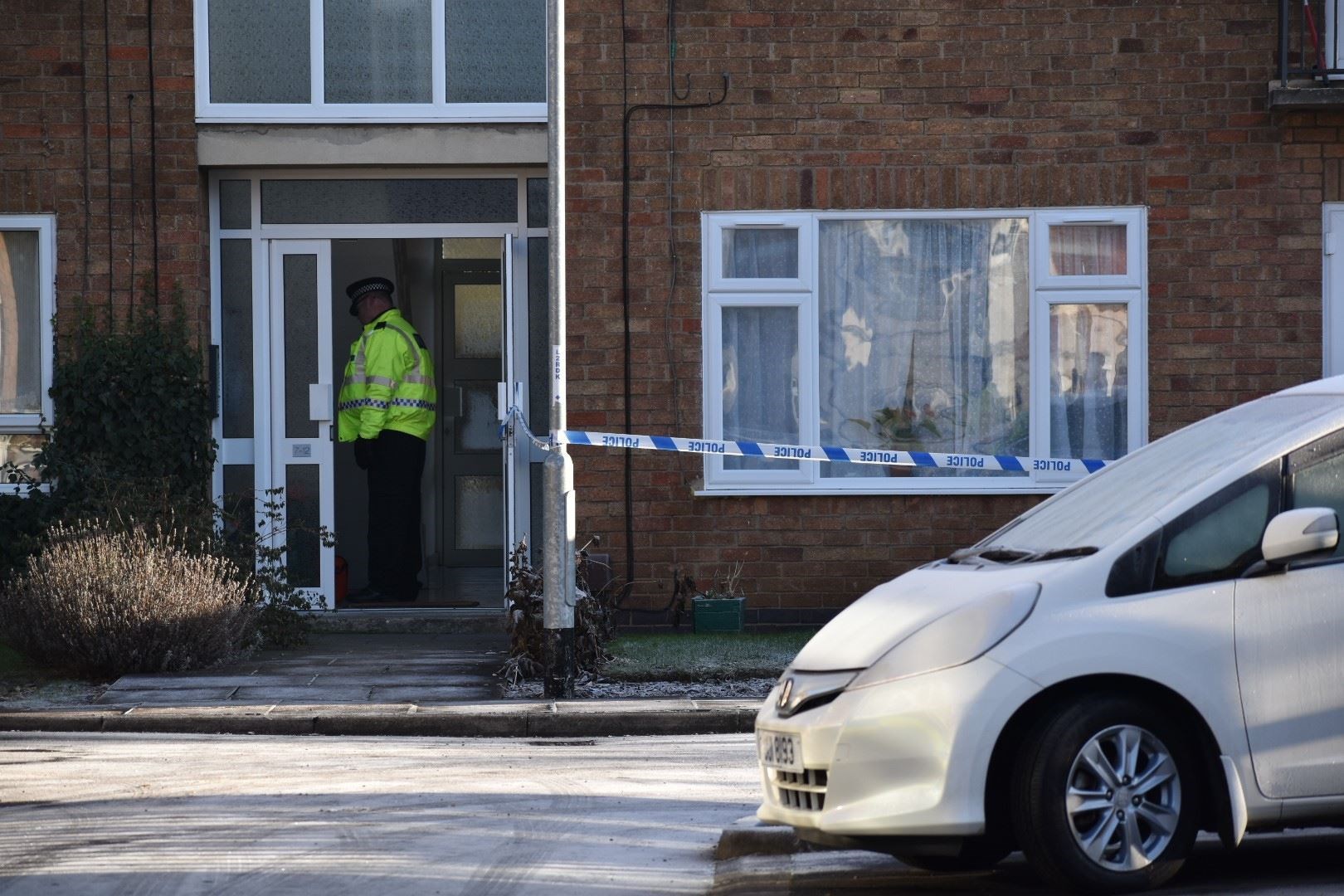 Forensic officers have been seen examining a ground floor flat (Matthew Cooper/PA)