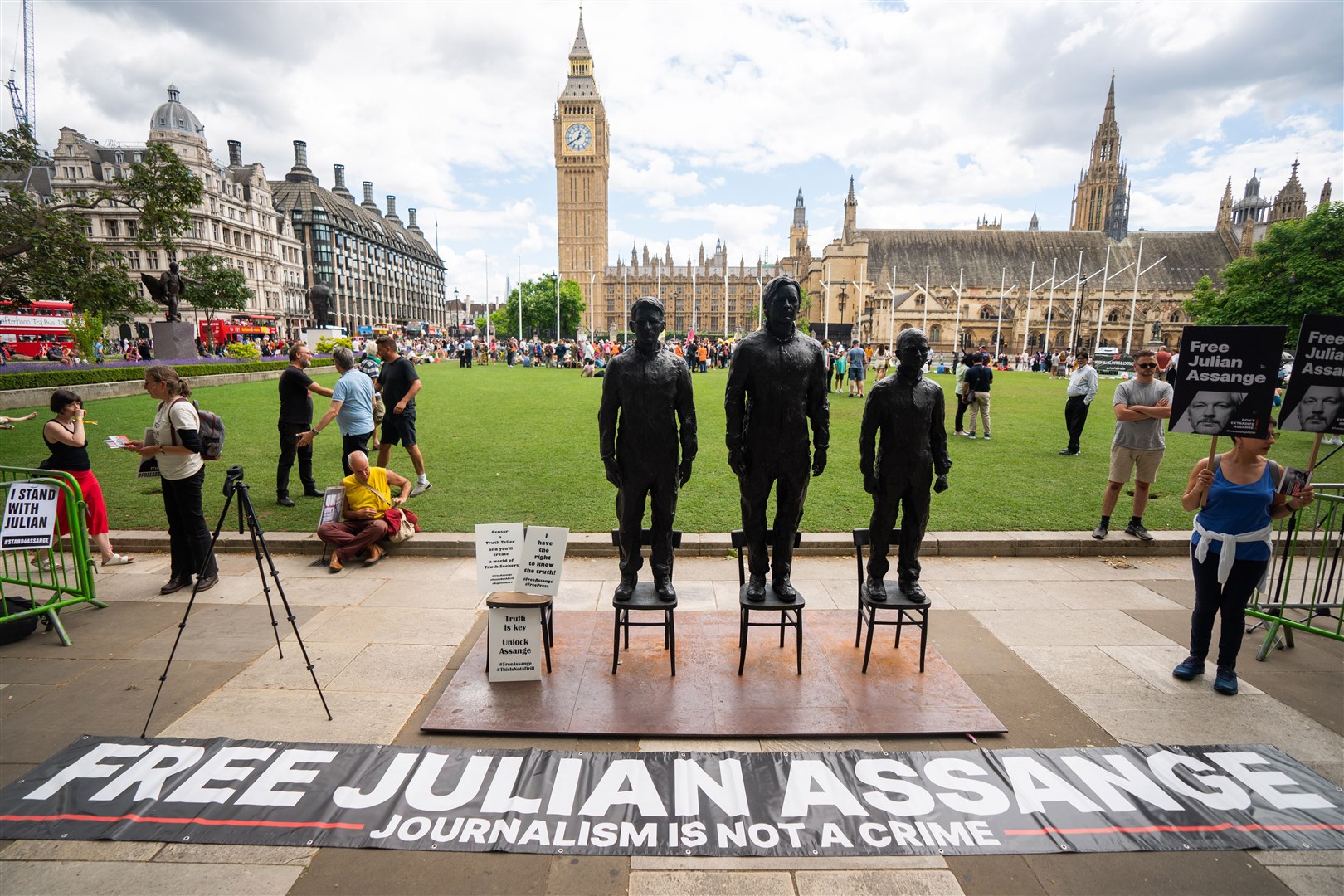 A sculpture called Anything To Say, which features life-sized bronze figures of whistleblowers (left-right) Edward Snowden, Julian Assange and Chelsea Manning, each standing on a chair, is unveiled at Parliament Square (James Manning/PA)