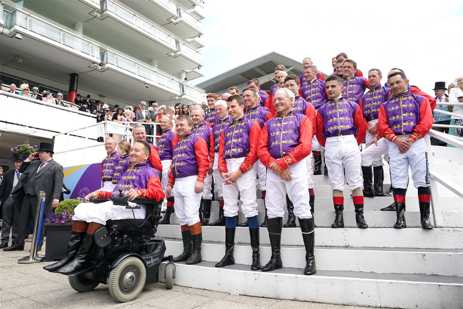 Jockeys who have ridden horses for the Queen lined up in her racing colours at Epsom (Tim Goode/PA)