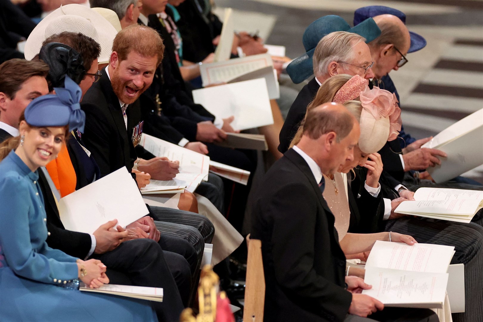 Harry reacts to another guest as does Princess Beatrice (Phil Noble/PA)