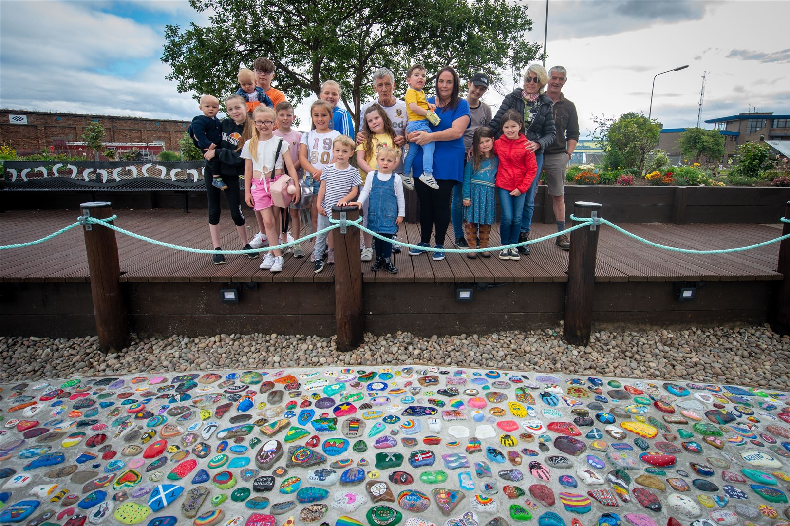 Peter, Charlotte and Suzie and Legge (centre) with some of the children who painted the stones. Picture: Callum Mackay