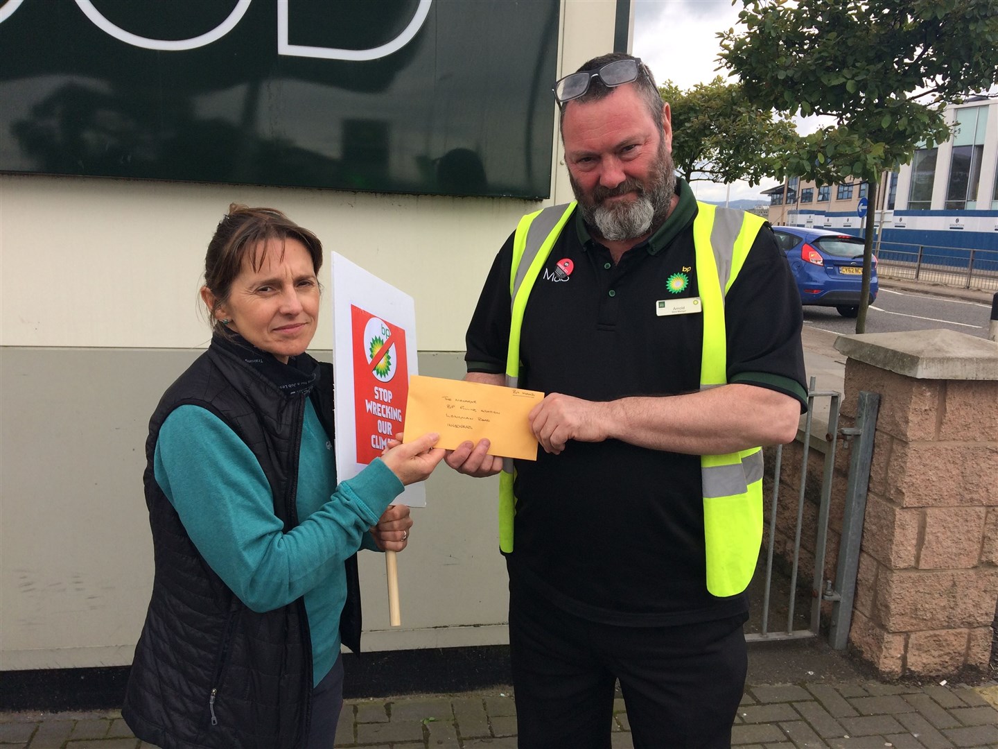 Jo Paterson (left) hands over the letter to a BP manager in Inverness following what was described as a good-natured protest.