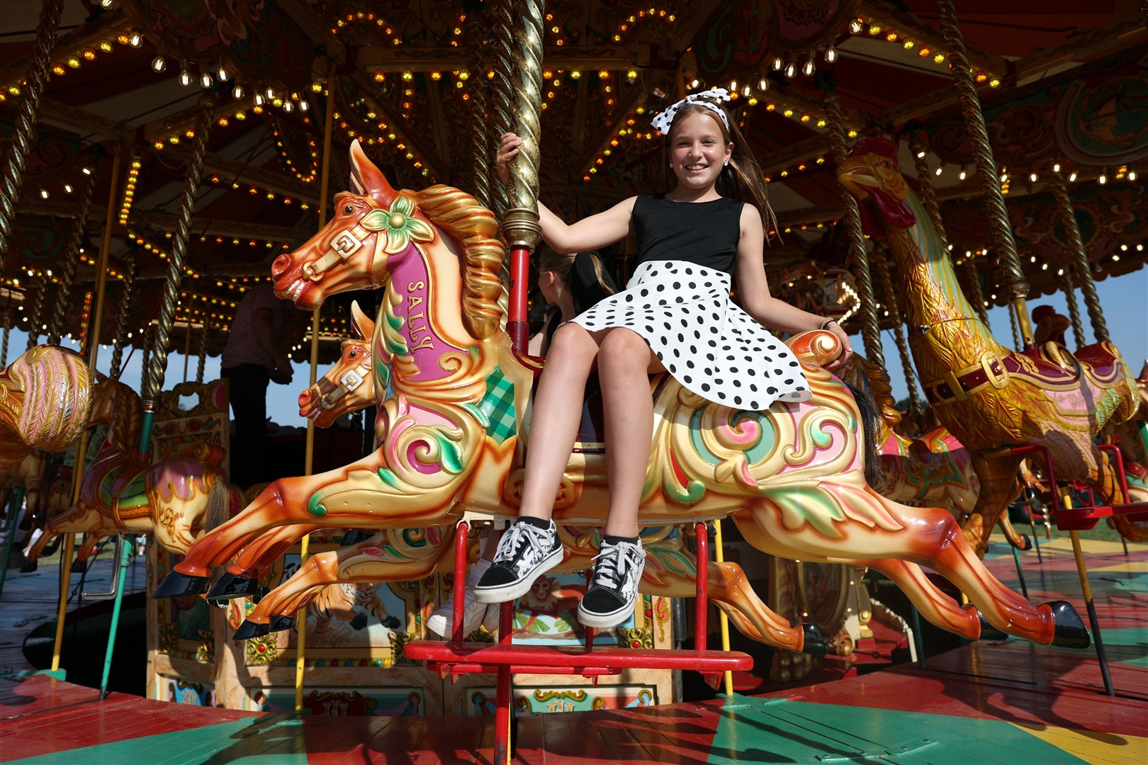 A young visitor enjoys the carousel at the vintage funfair (Kieran Cleeves/PA)