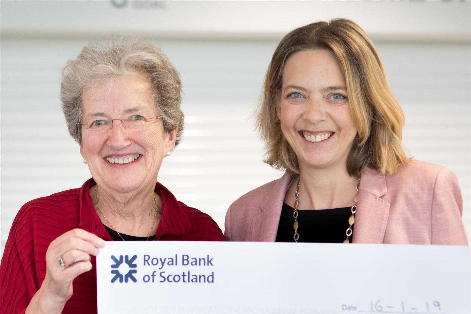 Sheila Proudfoot of the Elsie Normington Foundation is presented with a cheque from HBW for £4000 by last year's HBW president Jillian Sharp (right).