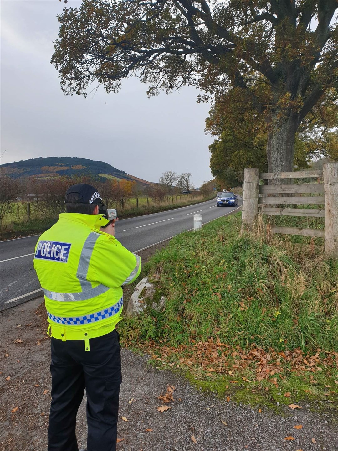 A police officer monitors vehicle speeds near Beauly.