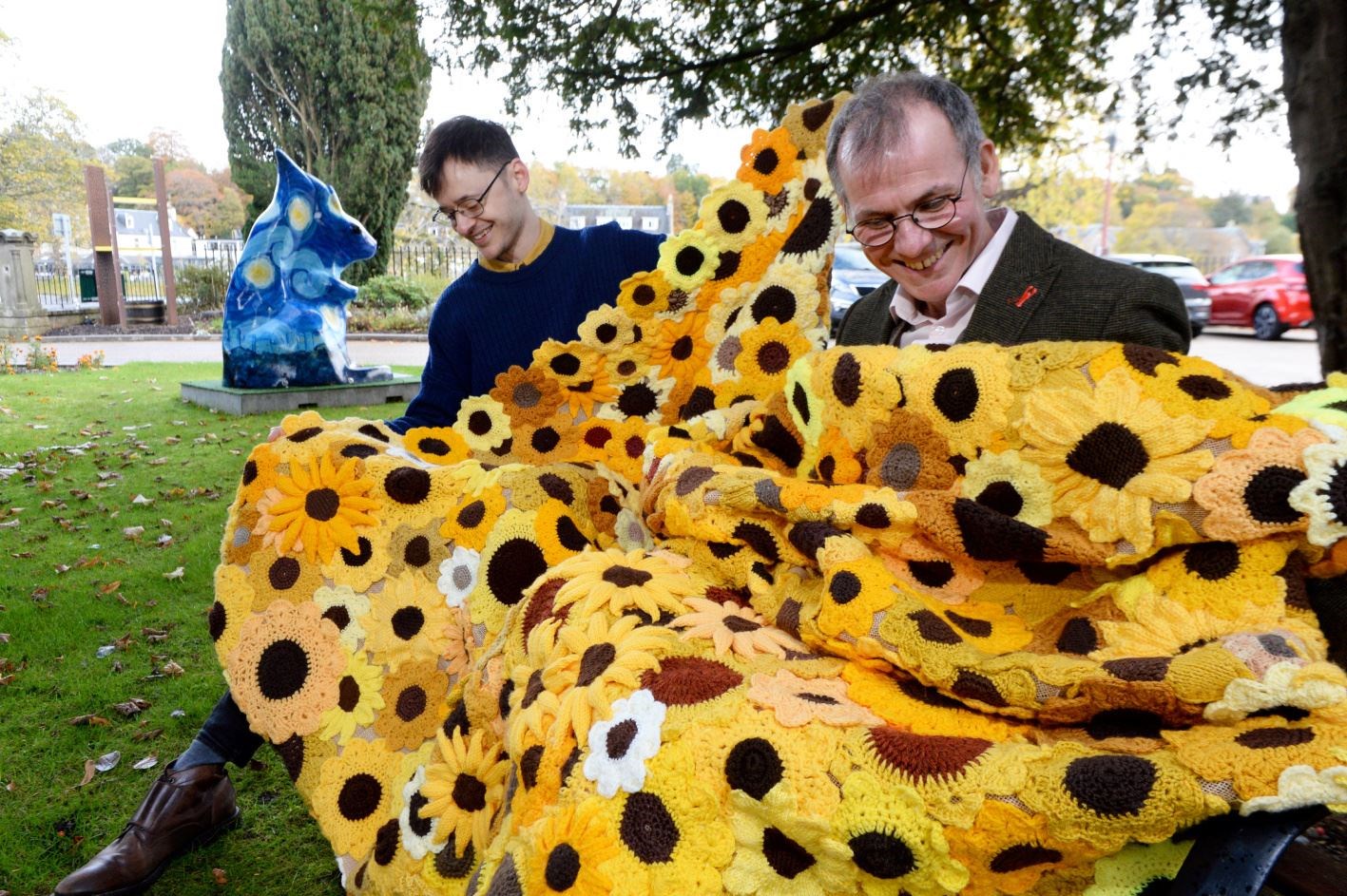 Joe Setch, Inverness Museum assistant receives one of the sunflower cascades from Andrew Leaver, Highland Hospice fundraising manager. Picture: James Mackenzie