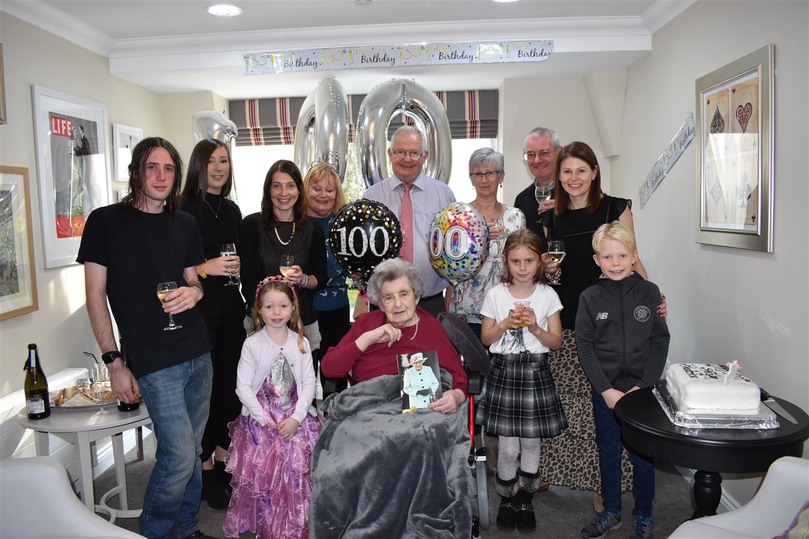 Beatrice Mackay with friends and family at her recent 100th birthday celebration.