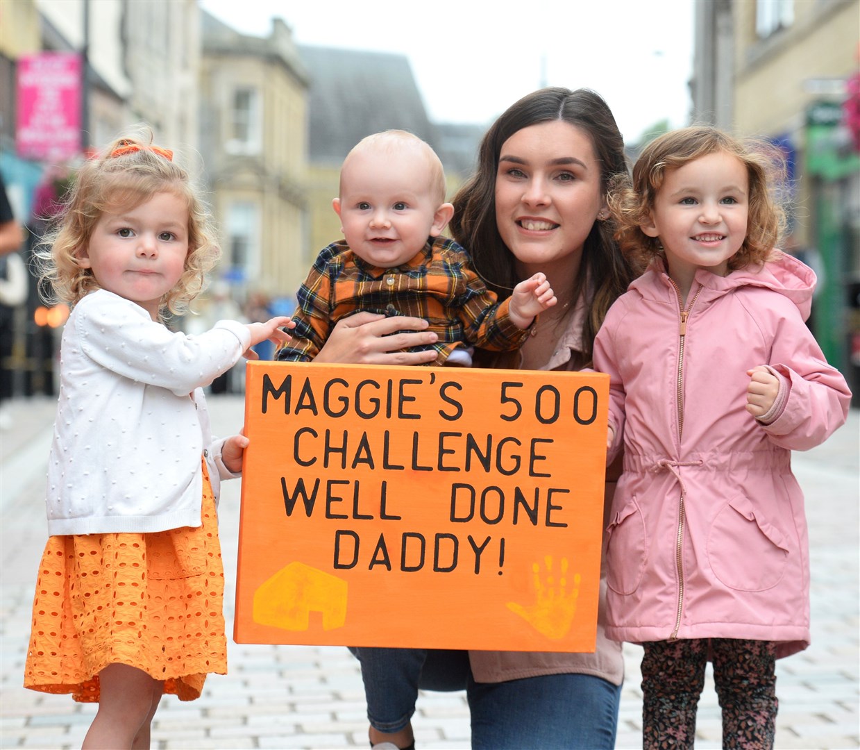 Maggie's 500 cycle finishes on Inverness High Street.Awaiting the arrival of Andrew MacKay is Isla,Callum and Susan Mackay with Ella Smith.Picture Gary Anthony.