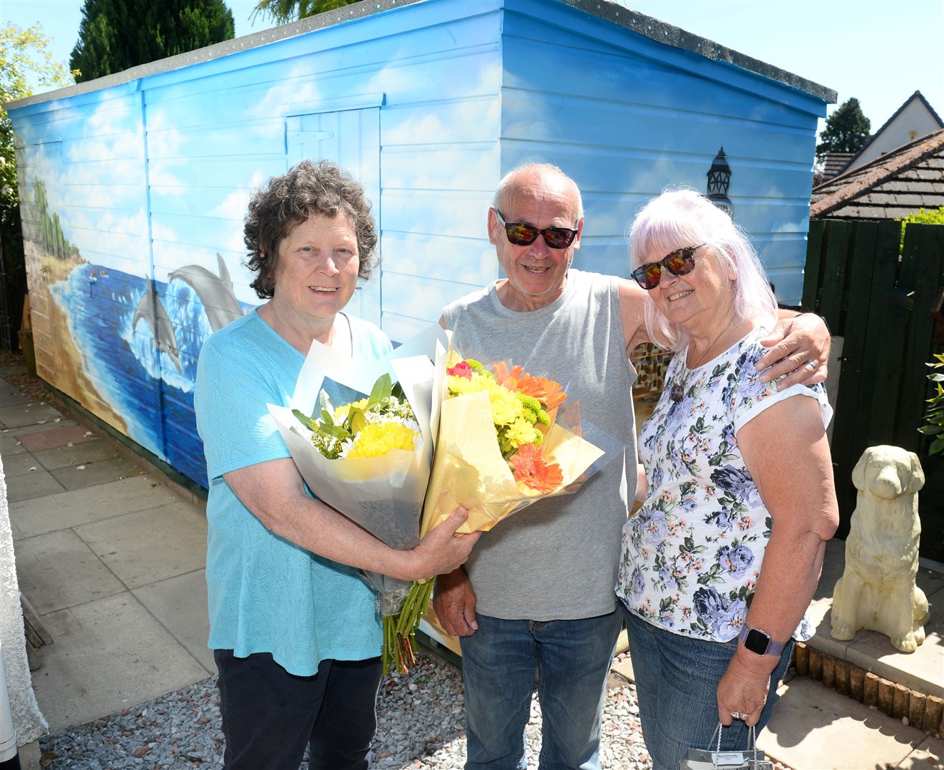 Iona Nicol presented Rhona Dalgarno and husband Jimmy Doull with flowers for their super fundraising efforts last summer. Picture: Gary Anthony