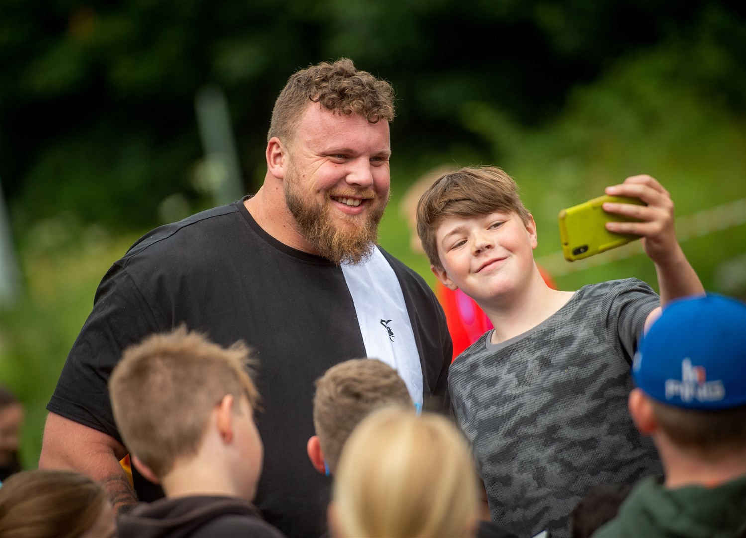 Harry Urquhart grabs a selfie with the World’s Strongest Man, Tom Stoltman, during one of his visits to The Field in Alness. Picture: Callum Mackay