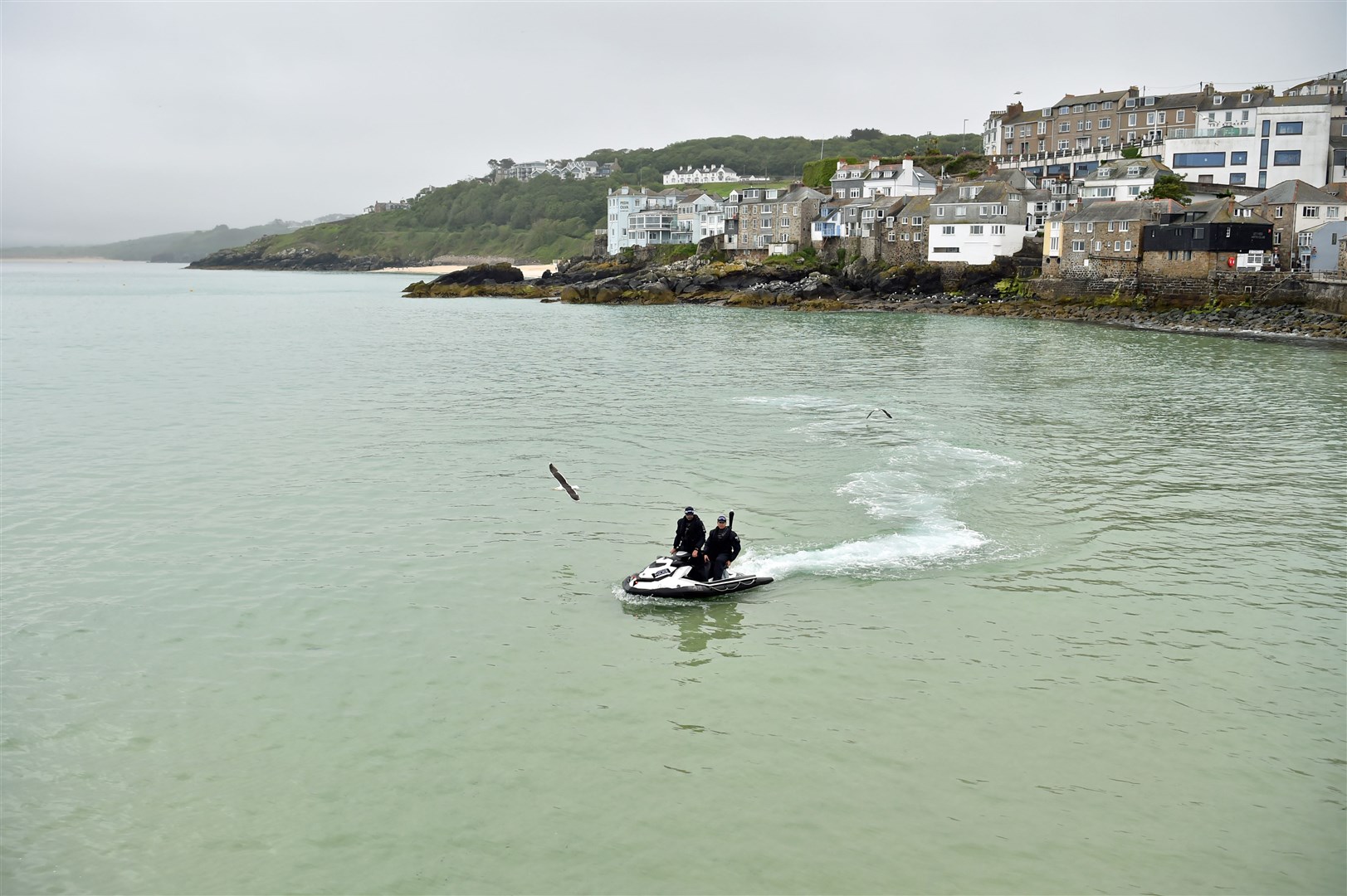 Police officers on a jet ski patrol the bay in St Ives during the G7 summit in Cornwall (Ben Birchall/PA)