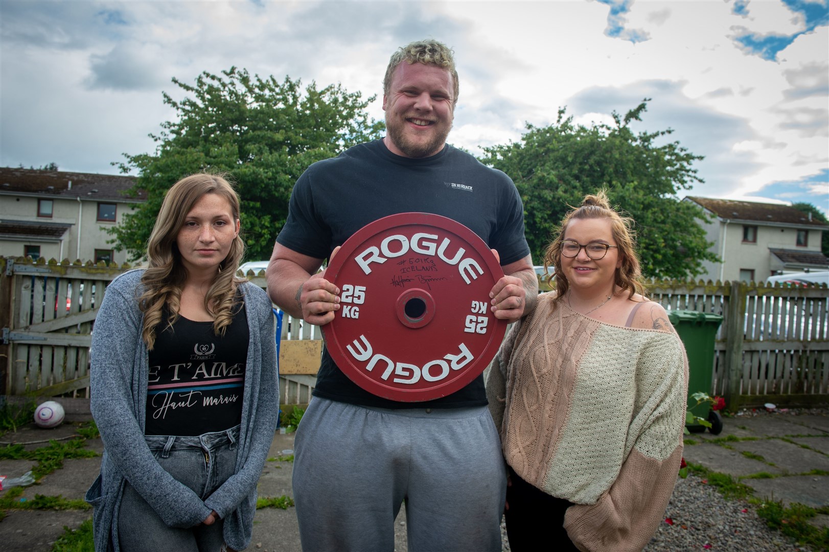Tom Stoltman fundraising for his wife's sister Sandie Tulloch, who lost her son Maximus at eight months to cot death. Sandie Tulloch, Tom and Sinead Stoltman. Picture: Callum Mackay