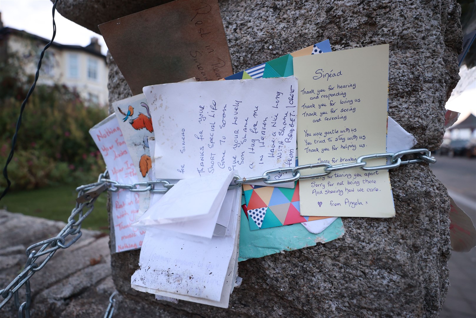 Notes left among the flowers and tributes outside her home (Liam McBurney/PA)