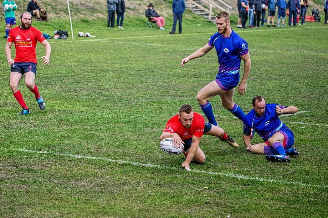 Kenny Horsfield scoring one of his three tries against North Police. Picture: Peter Carson