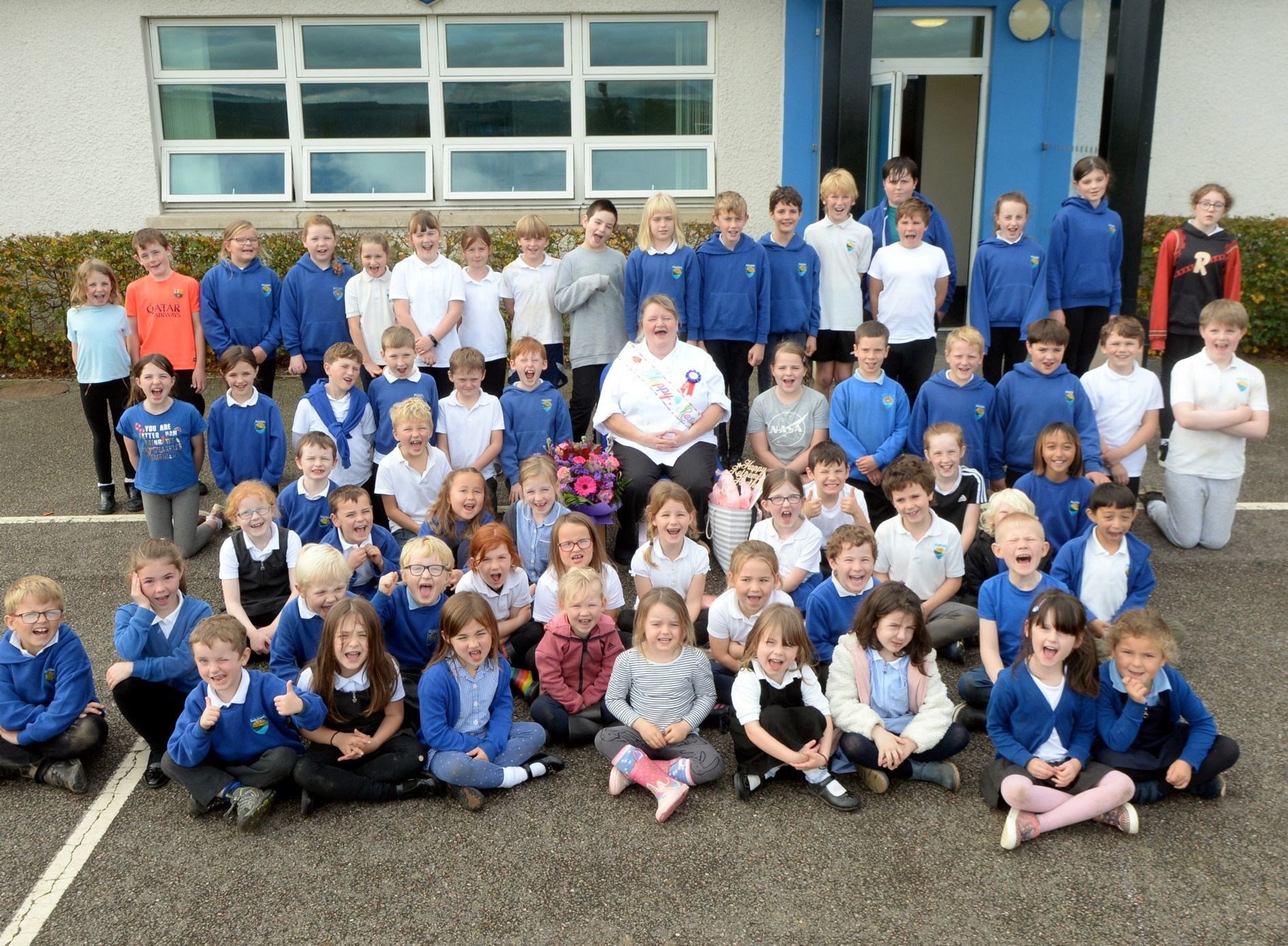 Heather Matheson with kids at Resolis Primary School who she served on her last day at work. Picture: James Mackenzie