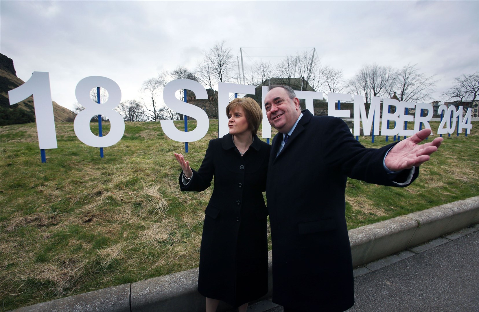 Then-first minister Alex Salmond and Deputy First Minister Nicola Sturgeon walk past a sign showing the date for the Scottish independence referendum in 2014 (David Cheskin/PA)