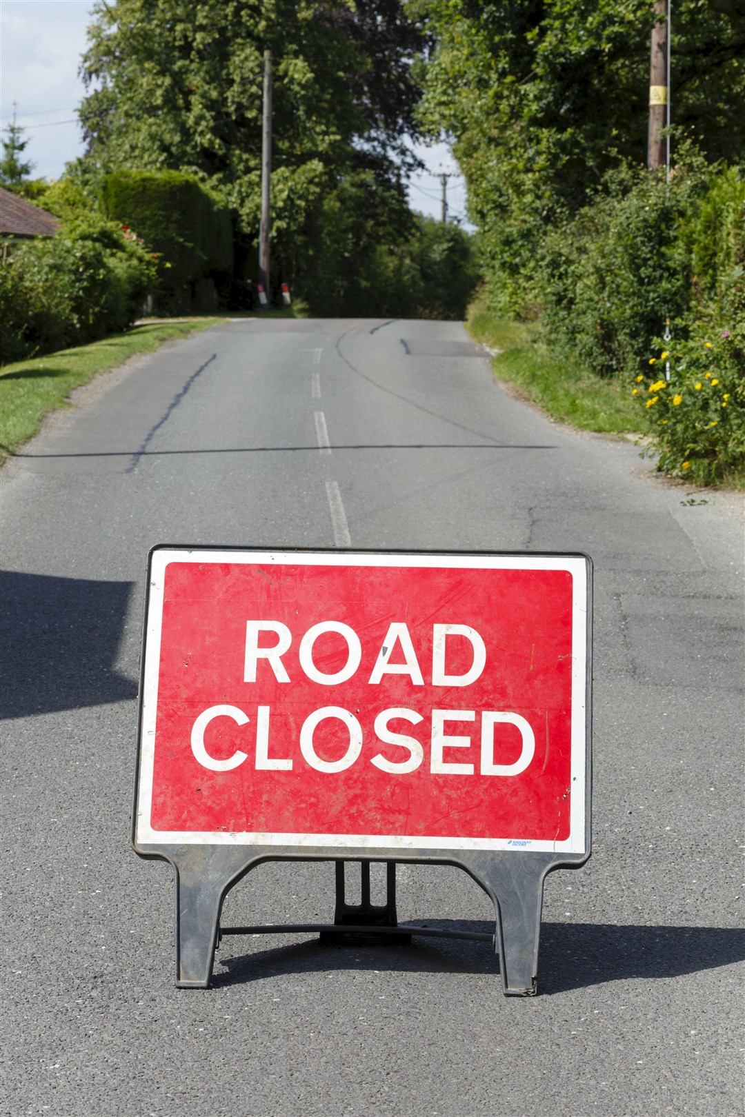 Road sign on a street showing a road closure.