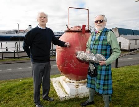 Invergordon Museum volunteers Donald Clark (left) and John Campbell-Smith who are organsing a comemoration to HMS Natal. Mr Campbell-Smith holds part of a silver cup won by the crew in a shooting competition and salvaged from the ship. Picture: Ian Rhind.