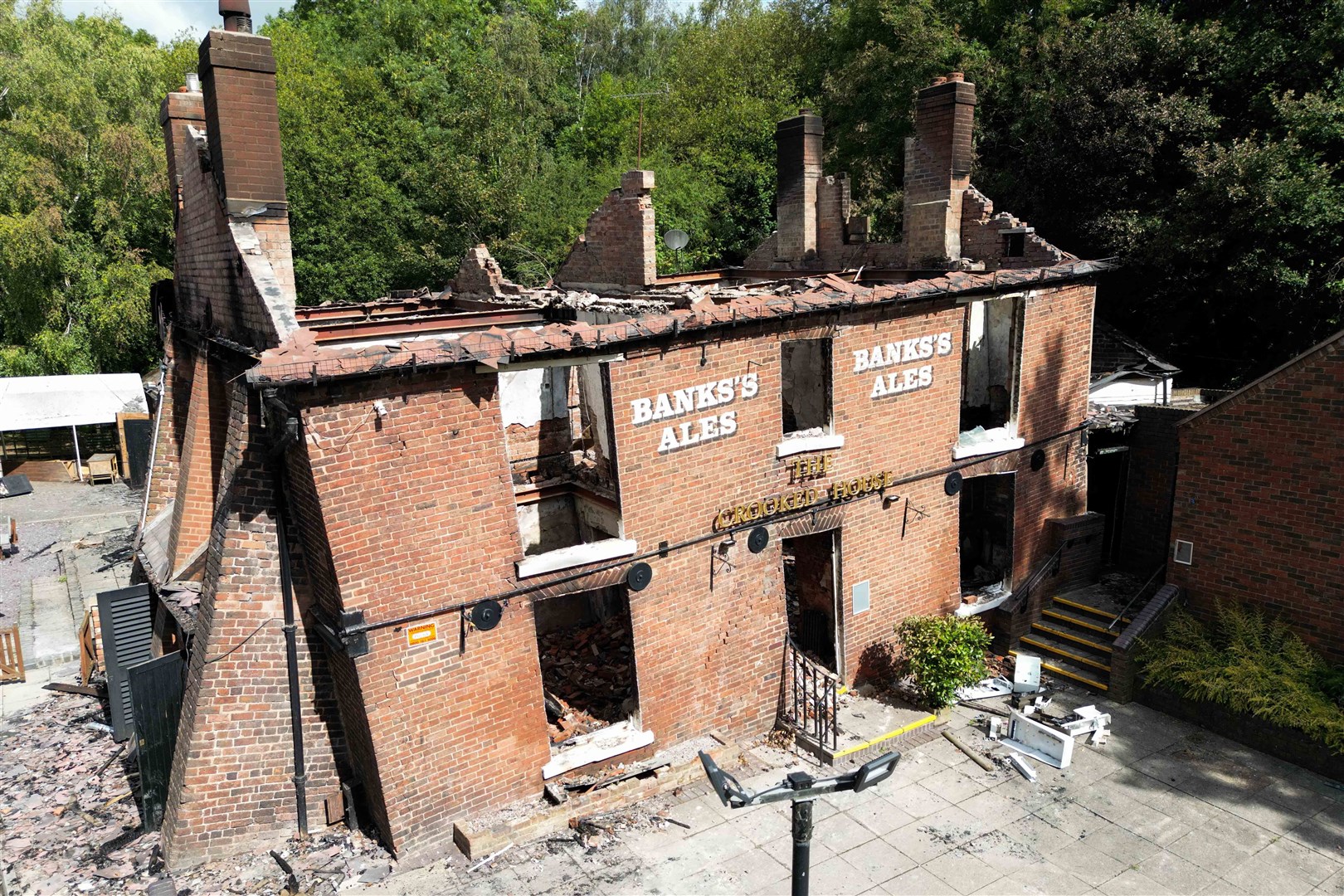The burnt-out remains before Monday’s demolition (Jacob King/PA)
