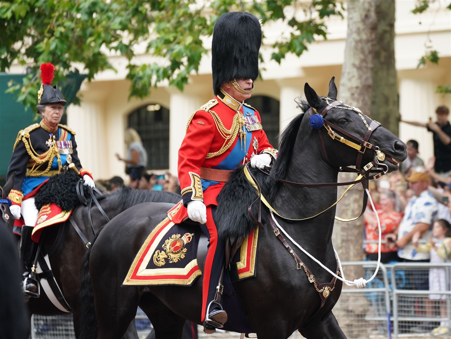 Charles steadies his horse during the procession along The Mall (Yui Mok/PA)