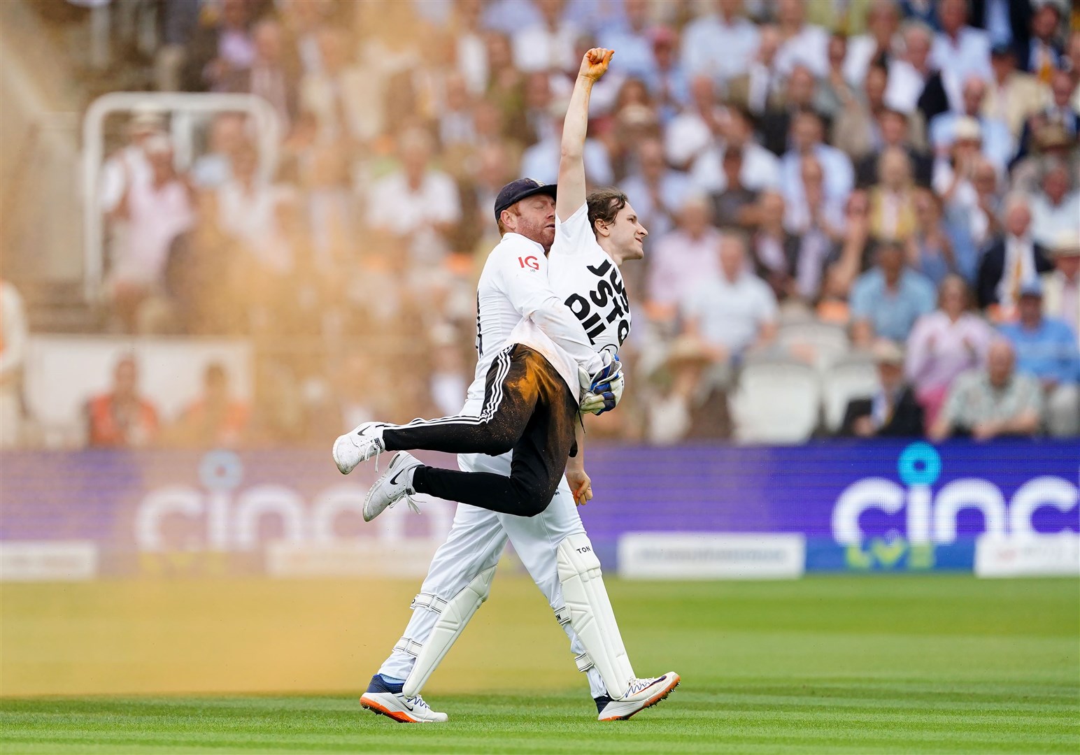 England’s Jonny Bairstow removes a Just Stop Oil protester from the pitch during day one of the second Ashes Test match at Lords, London, in June (Mike Egerton/PA)
