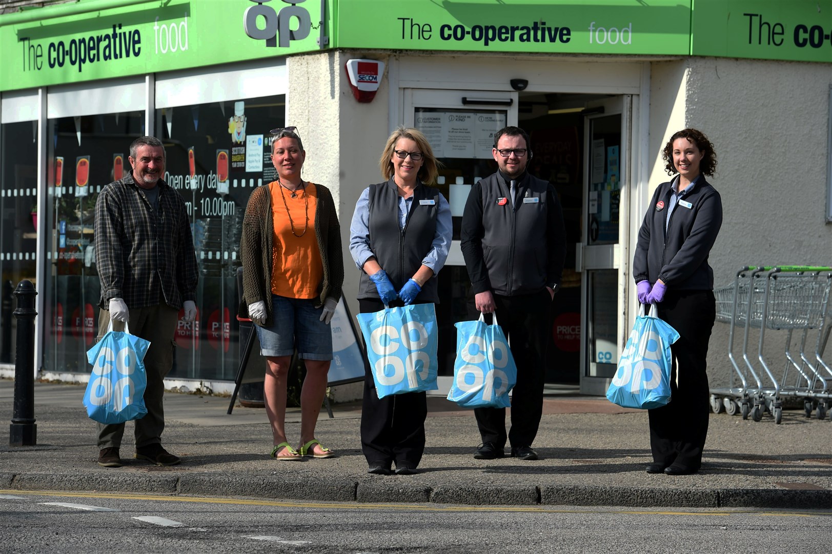 Evanton Co-op staff and helpers have gone the extra mile delivering to customers in their own time. From left, Hugh and Blandine Lynch, Lynda Ross, Stephen Scott and Melanie Macleod Picture: Callum Mackay.