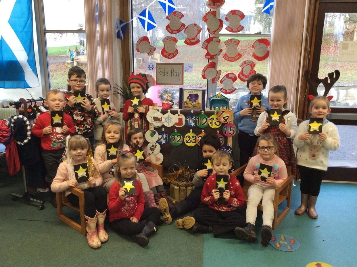Pupils with packages as part of the Alness Christmas Kindness Project.