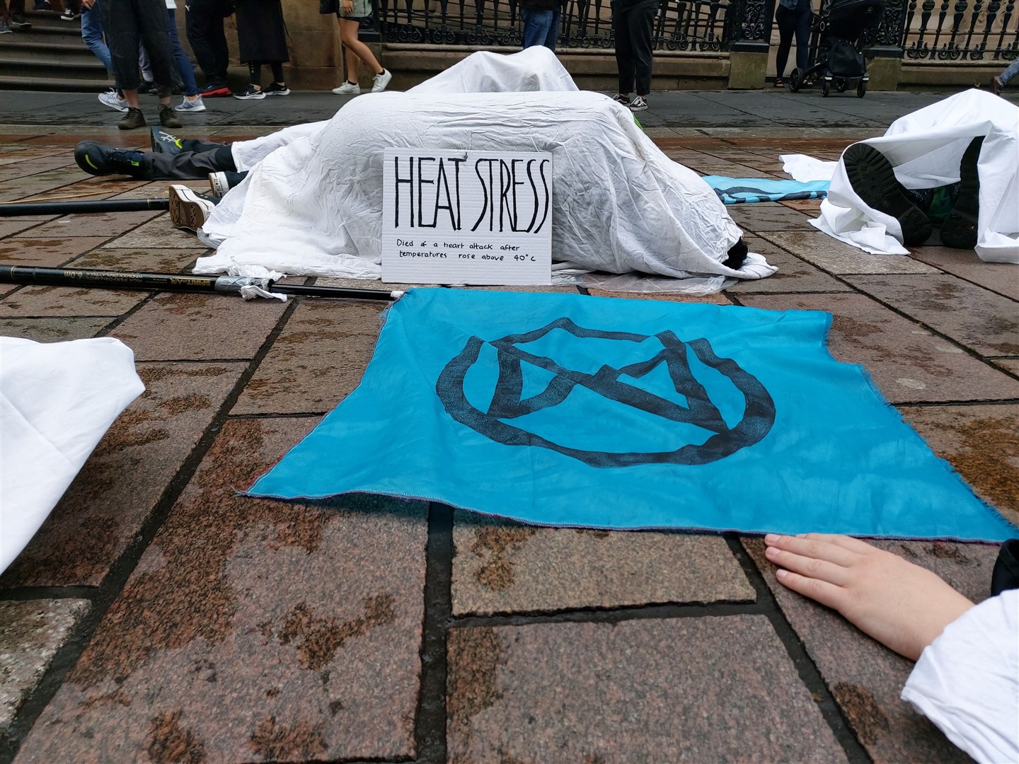 Extinction Rebellion protesters staged a ‘die in’ on Glasgow’s Buchanan Street following the heatwave (Extinction Rebellion Scotland/PA)